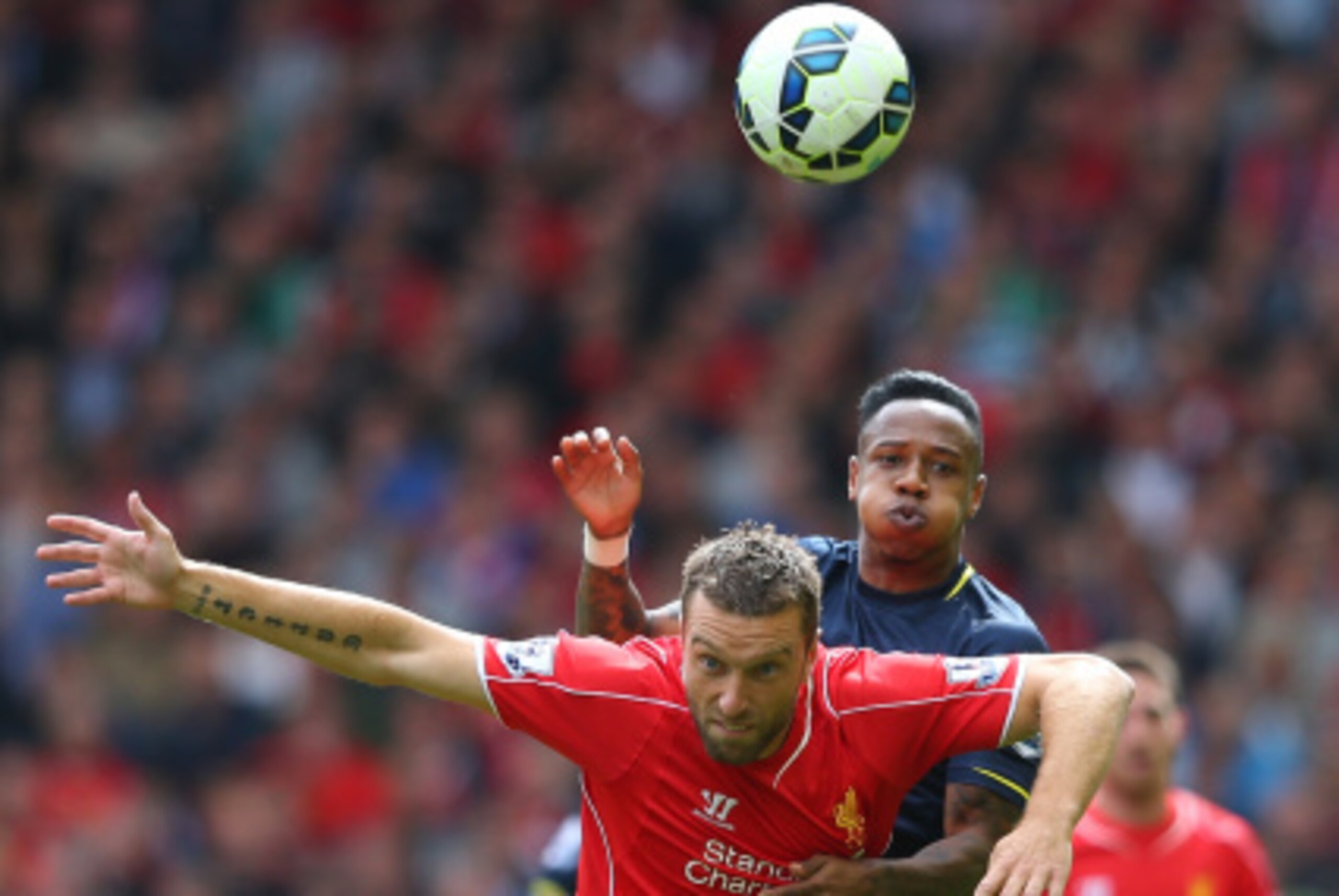 LIVERPOOL, ENGLAND - AUGUST 17:  Rickie Lambert of Liverpool holds off a challenge from Nathaniel Clyne of Southampton during the Barclays Premier League match between Liverpool and Southampton at Anfield on August 17, 2014 in Liverpool, England.  (Photo 