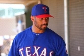 Mar 28, 2015; Surprise, AZ, USA; Seattle Seahawks quarterback Russell Wilson practices with the Texas Rangers on the practice fields at Surprise Stadium. Mandatory Credit: Mark J. Rebilas-USA TODAY Sports