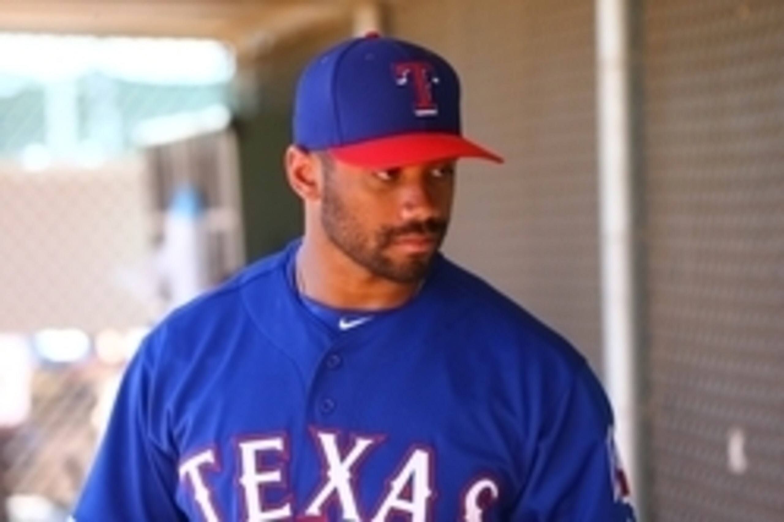 Mar 28, 2015; Surprise, AZ, USA; Seattle Seahawks quarterback Russell Wilson practices with the Texas Rangers on the practice fields at Surprise Stadium. Mandatory Credit: Mark J. Rebilas-USA TODAY Sports