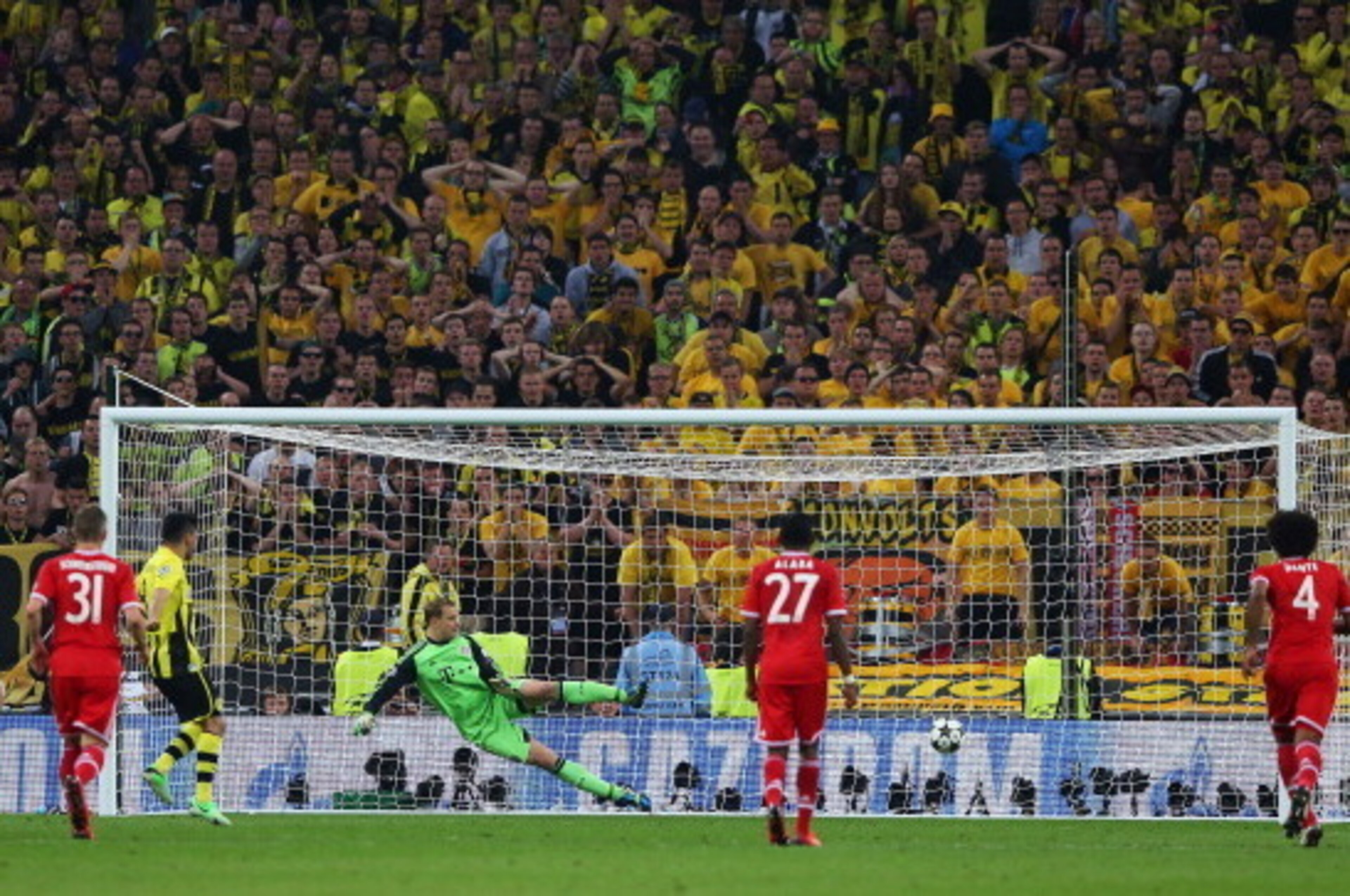 LONDON, ENGLAND - MAY 25: Ilkay Gundogan of Borussia Dortmund scores a goal from the penalty spot past Manuel Neuer of Bayern Muenchen during the UEFA Champions League final match between Borussia Dortmund and FC Bayern Muenchen at Wembley Stadium on May LONDON, ENGLAND - MAY 25: Ilkay Gundogan of Borussia Dortmund scores a goal from the penalty spot past Manuel Neuer of Bayern Muenchen during the UEFA Champions League final match between Borussia Dortmund and FC Bayern Muenchen at Wembley Stadium on May