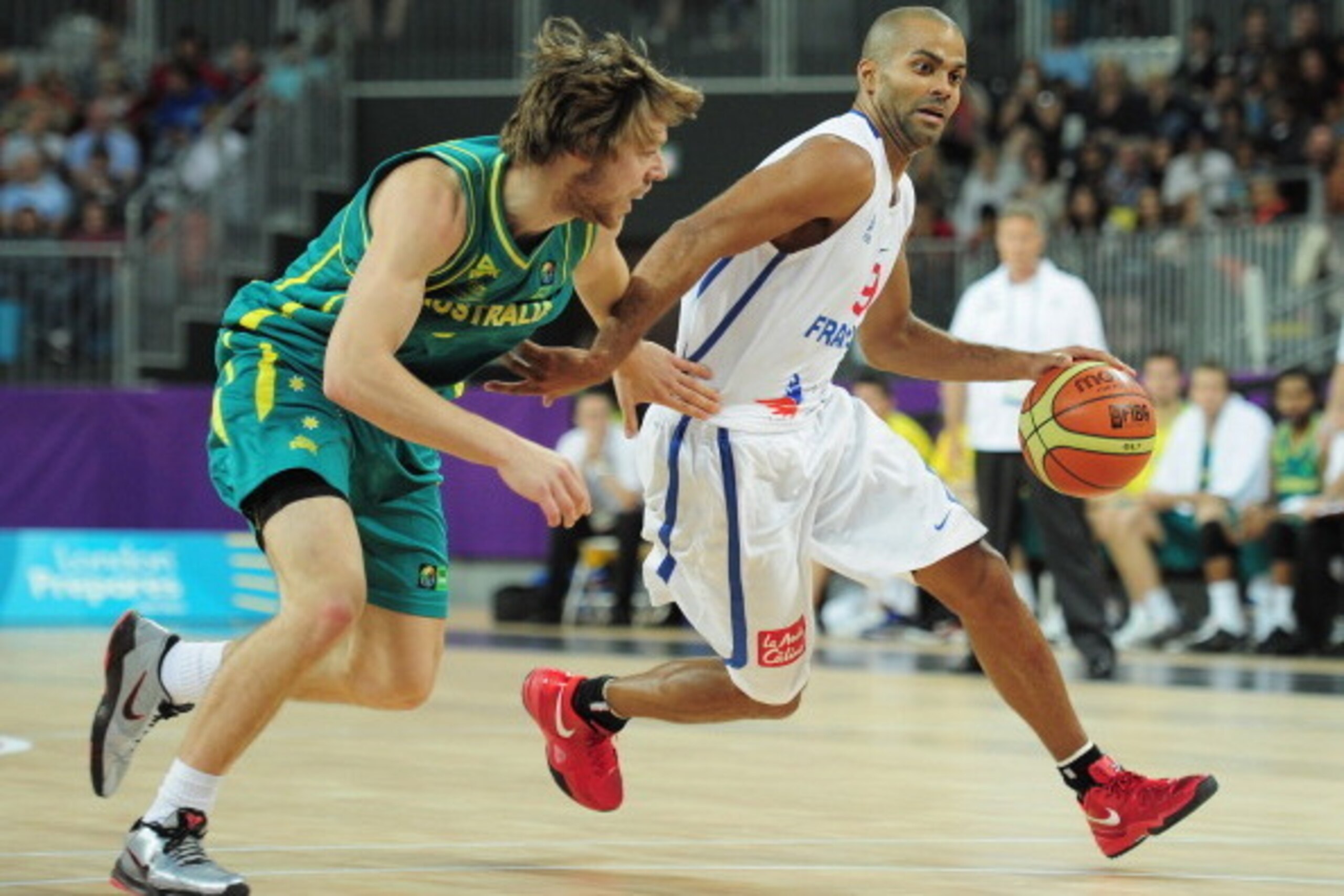 LONDON, ENGLAND - AUGUST 17:  Tony Parker of France is challenged by Matthew Dellavedova of Australia during the London Prepares Series match between France and Australia at the Basketball Arena on August 17, 2011 in London, England.  (Photo by Shaun Bott