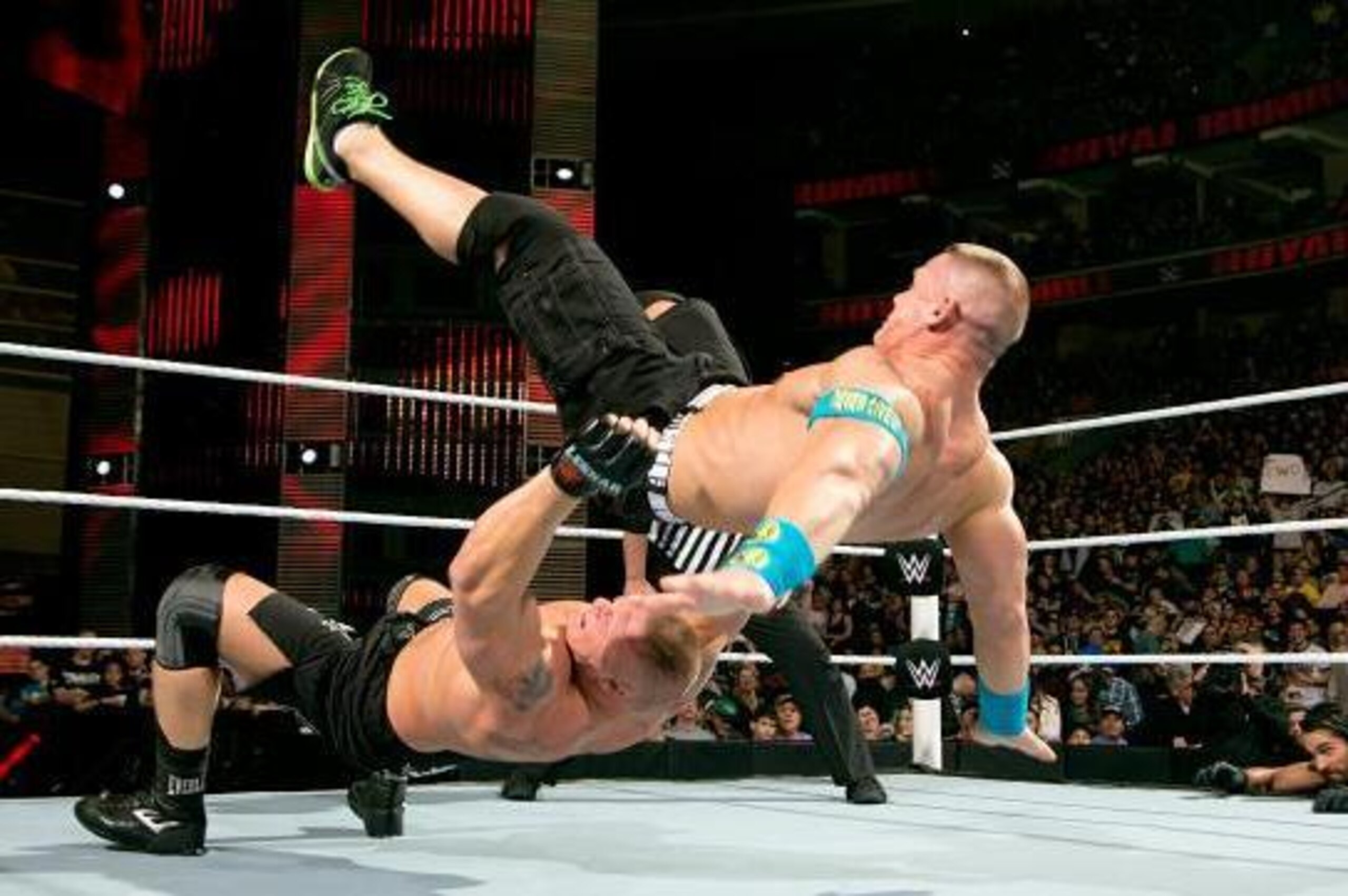 Brock Lesnar hits John Cena with a German suplex.