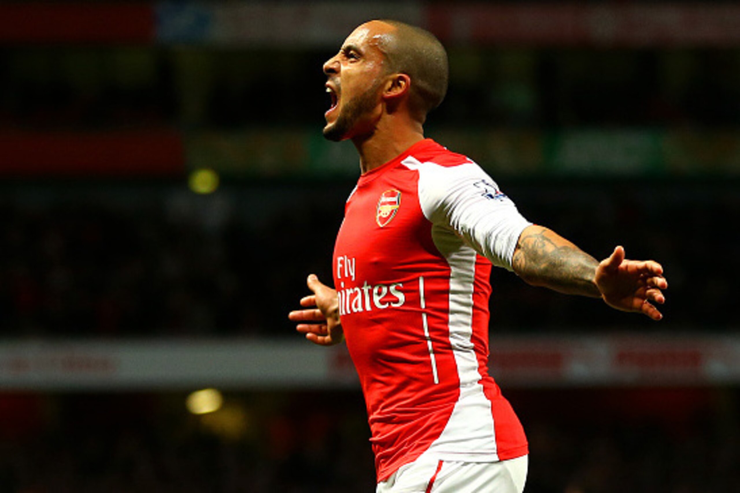 LONDON, ENGLAND - FEBRUARY 10:  Theo Walcott of Arsenal celebrates after scoring his team's second goal during the Barclays Premier League match between Arsenal and Leicester City at Emirates Stadium on February 10, 2015 in London, England.  (Photo by Ric