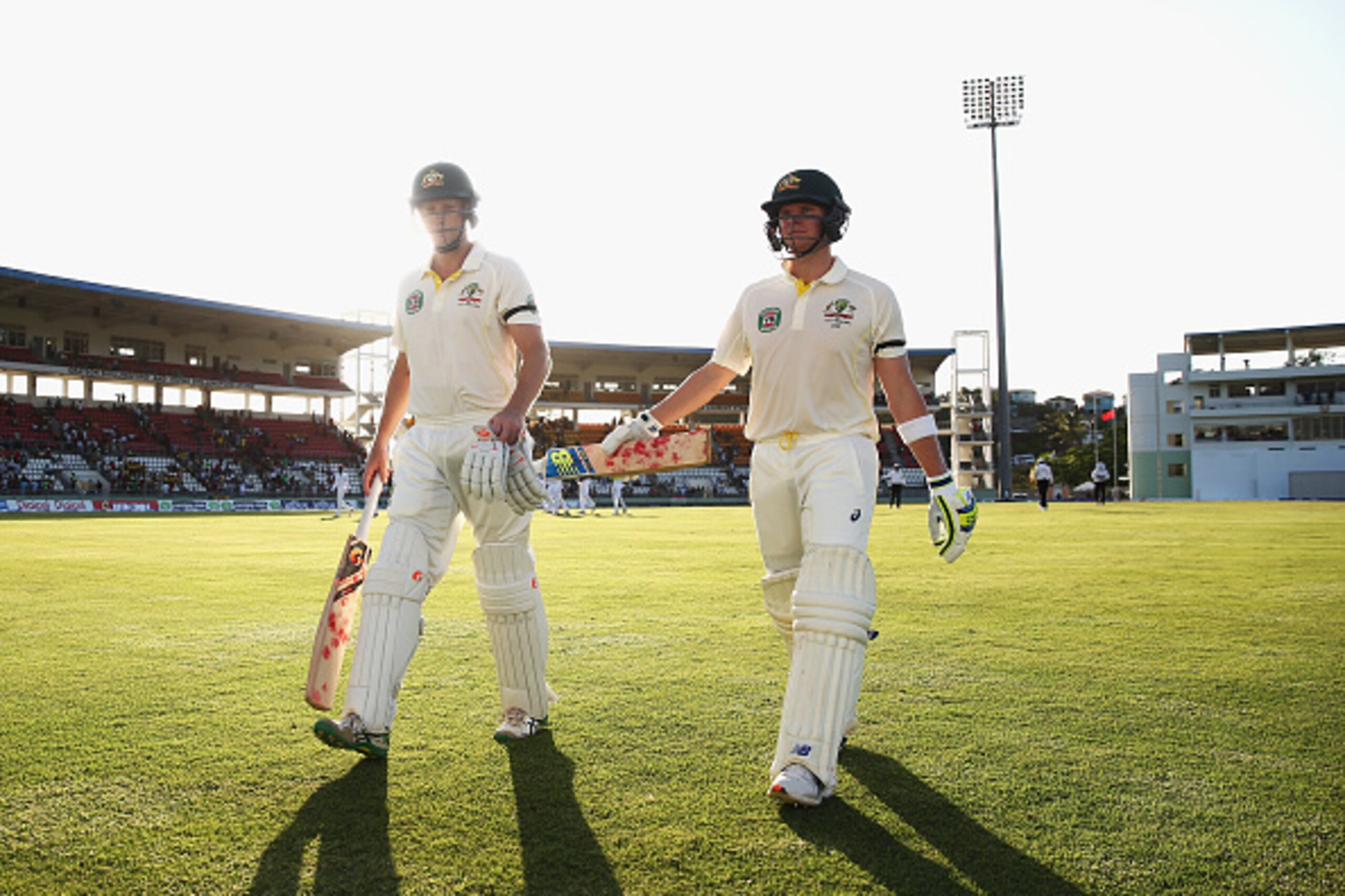 ROSEAU, DOMINICA - JUNE 03:  Adam Voges and Steve Smith of Australia leave the ground at stumps during day one of the First Test match between Australia and the West Indies at Windsor Park on June 3, 2015 in Roseau, Dominica.  (Photo by Ryan Pierse/Getty 