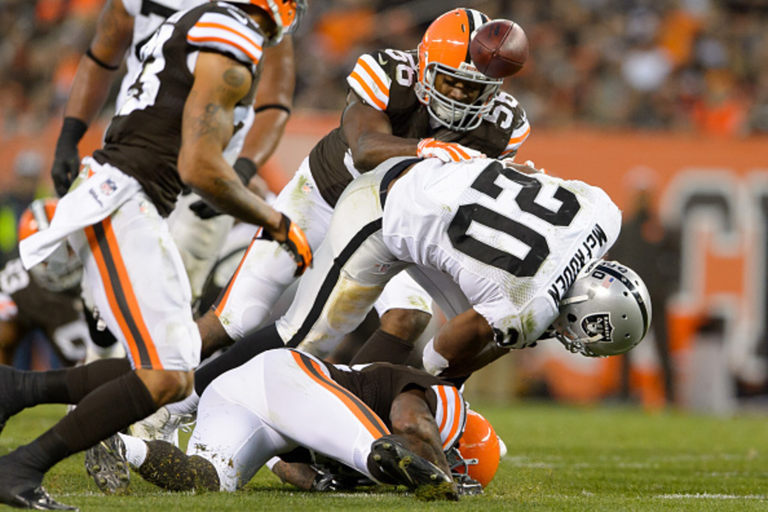 CLEVELAND, OH - OCTOBER 26: Running back Darren McFadden #20 of the Oakland Raiders loses the ball as he is tackled during the second half against the Cleveland Browns at FirstEnergy Stadium in Cleveland, Ohio. The Browns defeated the Raiders 23-13. (Phot