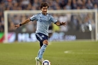 Mar 21, 2015; Kansas City, KS, USA; Sporting KC mid-fielder Benny Feilhaber (10) pushes the ball up field against the Portland Timbers during the first half at Sporting Park. Mandatory Credit: Peter G. Aiken-USA TODAY Sports