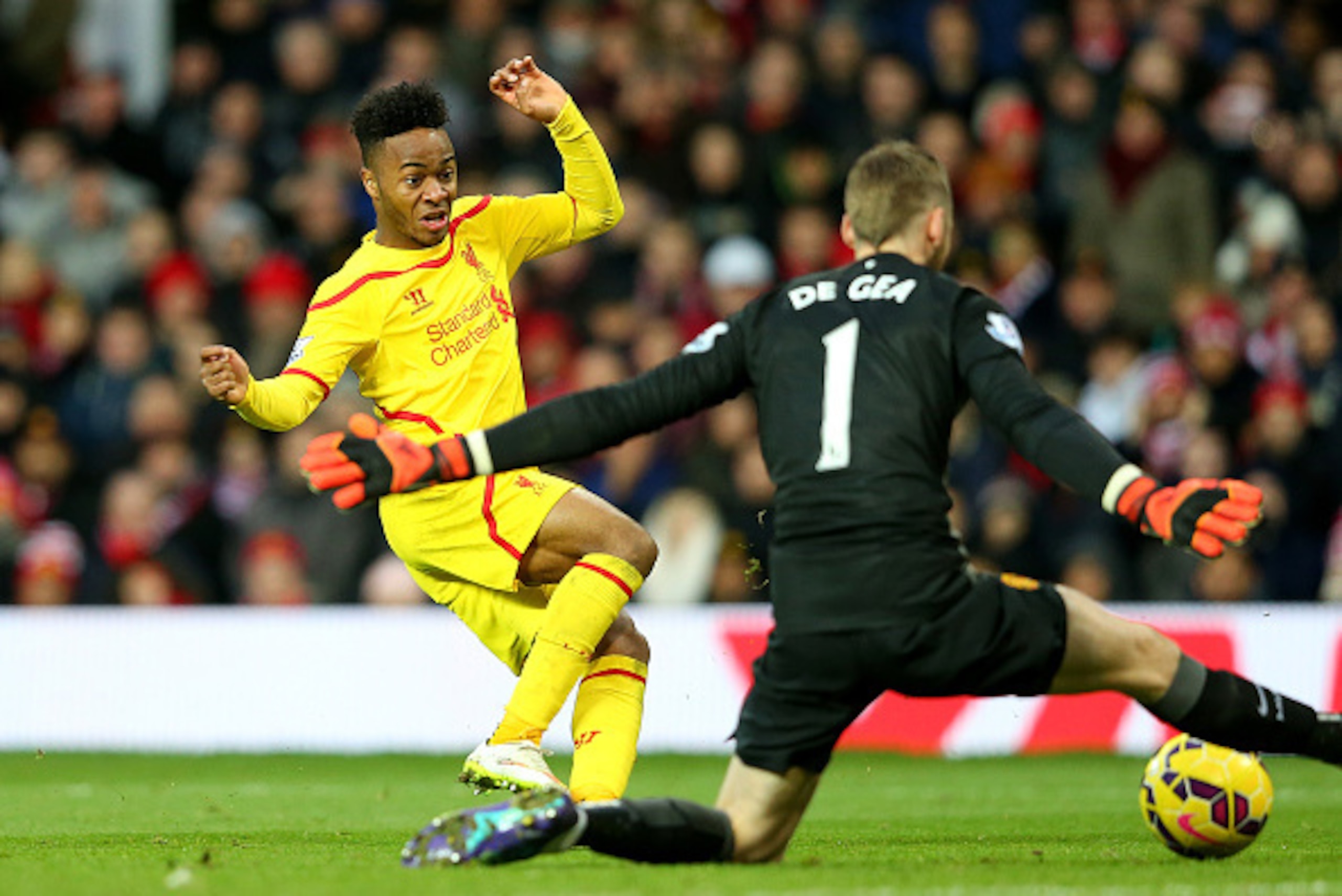 MANCHESTER, ENGLAND - DECEMBER 14:  Dvid De Gea of Manchester United saves the attempt on goal of Raheem Sterling of Liverpool in a one on one situation during the Barclays Premier League match between Manchester United and Liverpool at Old Trafford on De