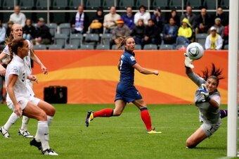 MOENCHENGLADBACH, GERMANY - JULY 13:  Gaetane Thiney of France (C) watches as a cross from Sonia Bompastor (not pictured) floats past Hope Solo of USA to make it 1-1 during the FIFA Women's World Cup 2011 Semi Final match between France and USA at Borussi