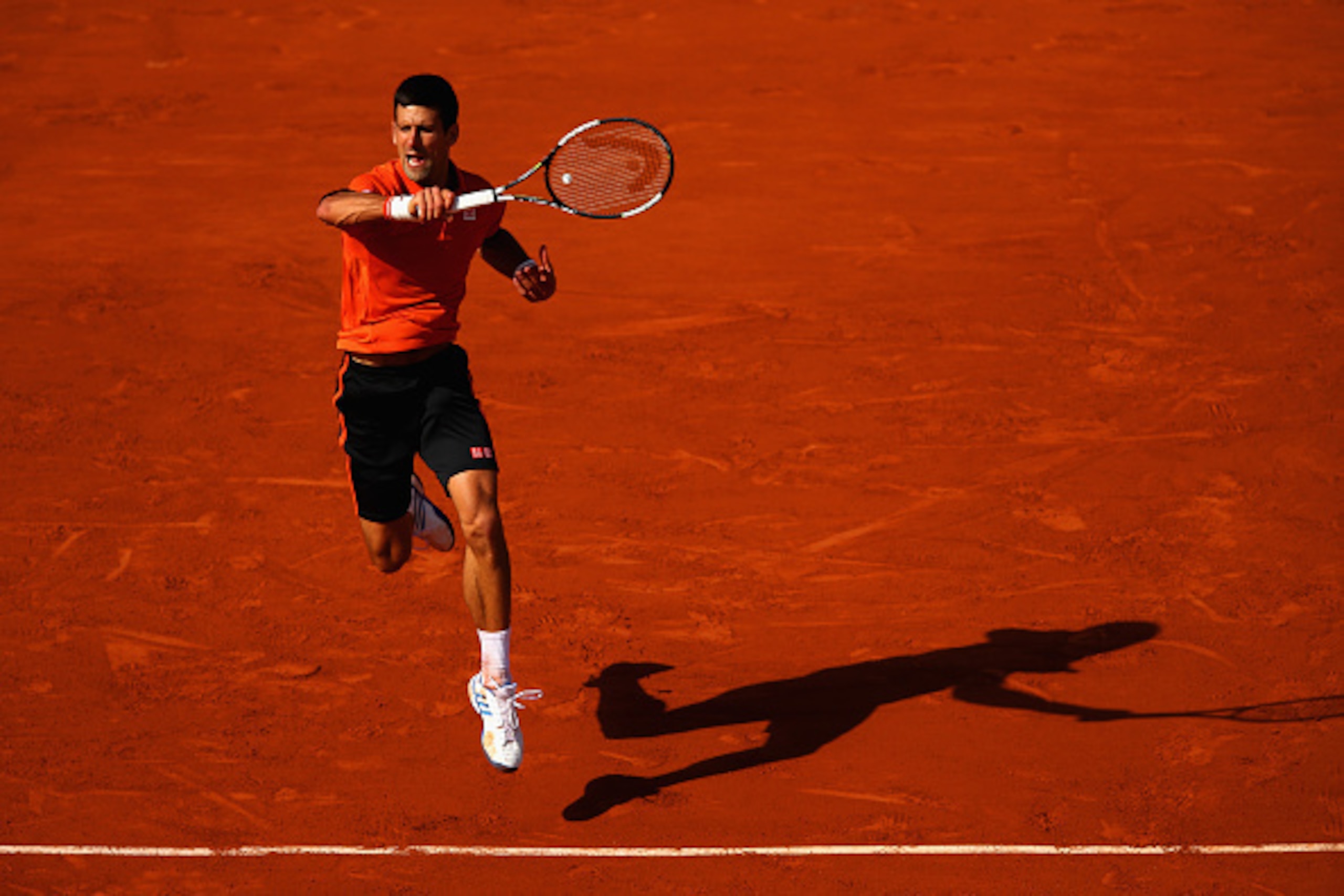 PARIS, FRANCE - JUNE 03:  Novak Djokovic of Serbia returns a shot in his Men's quarter final match against Rafael Nadal of Spain on day eleven of the 2015 French Open at Roland Garros on June 3, 2015 in Paris, France.  (Photo by Clive Brunskill/Getty Imag