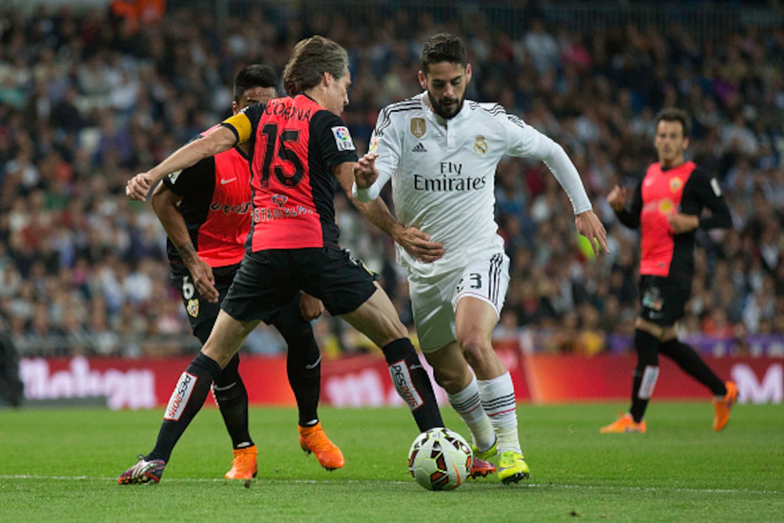 MADRID, SPAIN - APRIL 29: Francisco Roman Alarcon alias Isco (R) of Real Madrid CF competes for the ball with Miguel Angel Garcia Perez-Roldan alias Corona (L) of Almeria UD during the La Liga match between Real Madrid CF and UD Almeria at Estadio Santiag