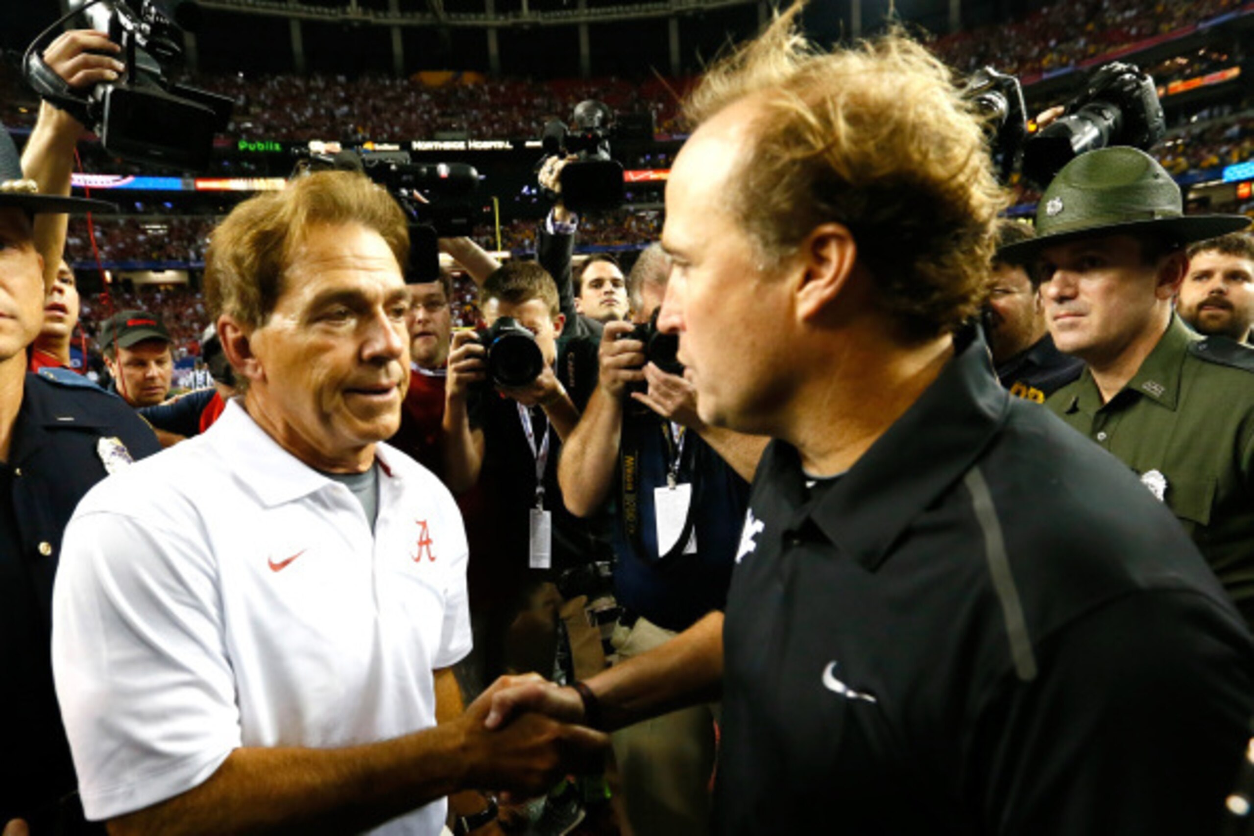 ATLANTA, GA - AUGUST 30:  Head coach Nick Saban of the Alabama Crimson Tide shakes hands with head coach Dana Holgorsen of the West Virginia Mountaineers after their 33-23 win at Georgia Dome on August 30, 2014 in Atlanta, Georgia.  (Photo by Kevin C. Cox