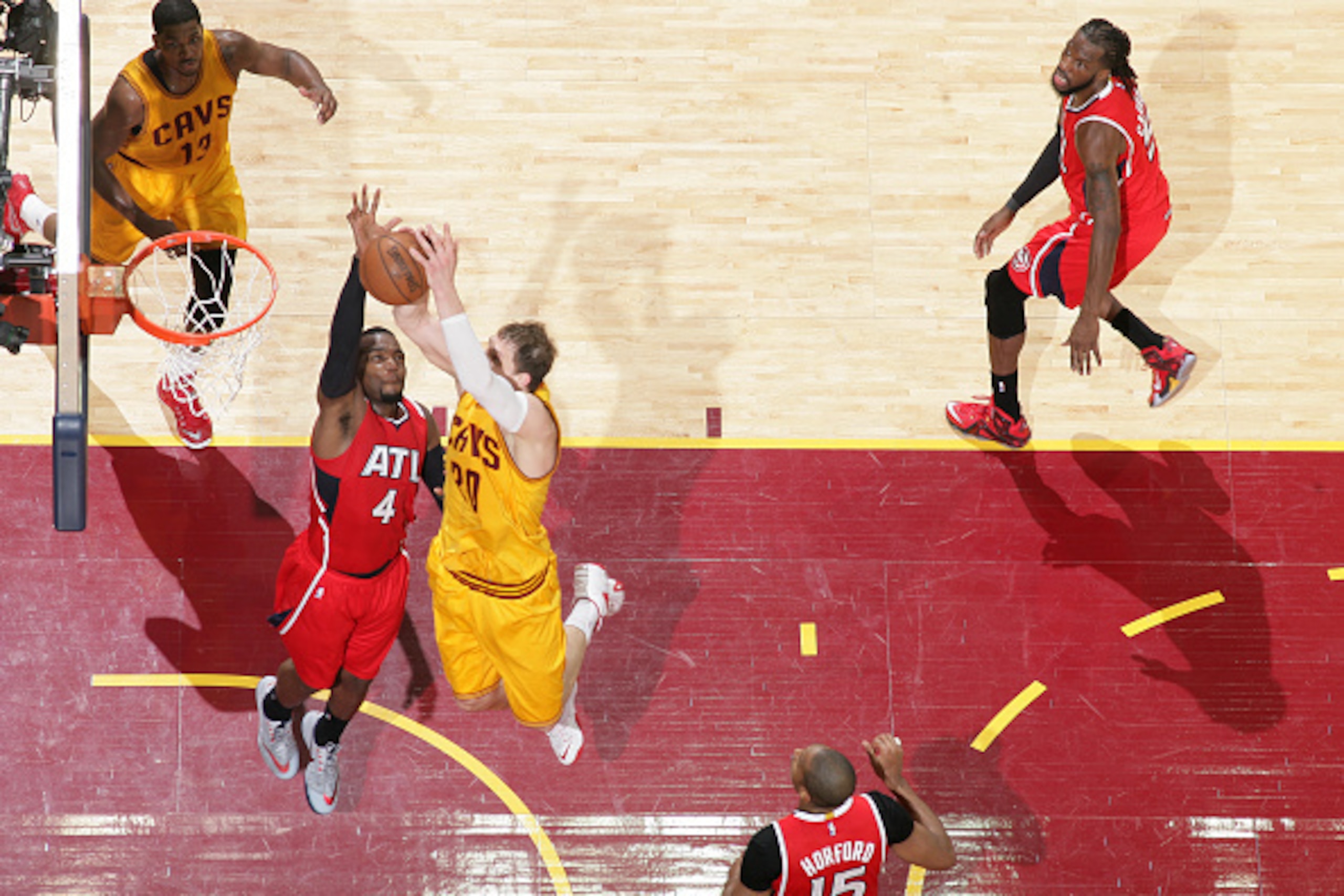 CLEVELAND, OH - MAY 26: Timofey Mozgov #20 of the Cleveland Cavaliers dunks against Paul Millsap #4 of the Atlanta Hawks in Game Four of the Eastern Conference Finals during the 2015 NBA Playoffs on May 26, 2015 at Quicken Loans Arena in Cleveland, Ohio. 