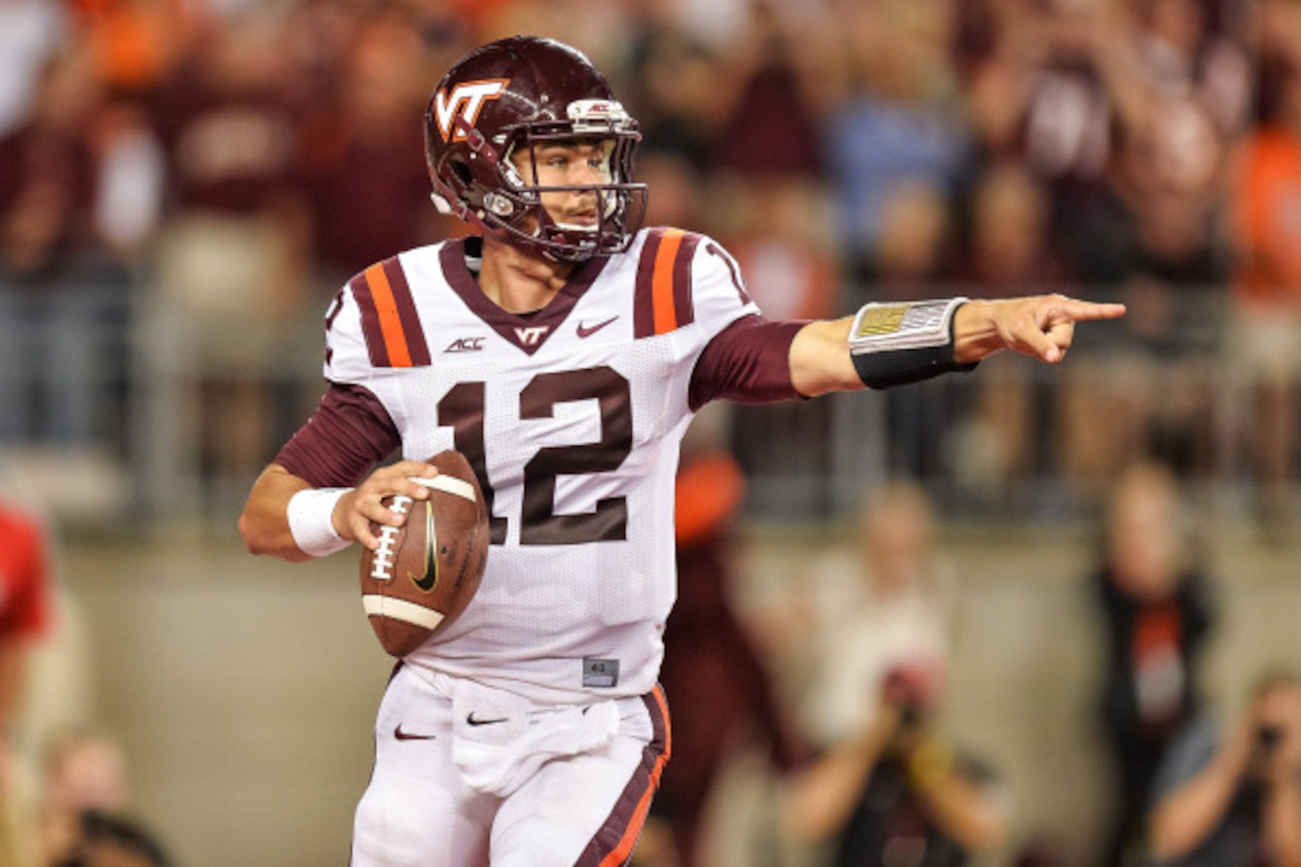COLUMBUS, OH - SEPTEMBER 6:  Quarterback Michael Brewer #12 of the Virginia Tech Hokies runs with the ball against the Ohio State Buckeyes at Ohio Stadium on September 6, 2014 in Columbus, Ohio.  (Photo by Jamie Sabau/Getty Images)