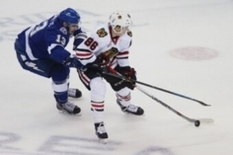 Jun 3, 2015; Tampa, FL, USA; Chicago Blackhawks left wing Teuvo Teravainen (86) battles for the puck with Tampa Bay Lightning center Cedric Paquette (13) in the first period in game one of the 2015 Stanley Cup Final at Amalie Arena. Mandatory Credit: Rein