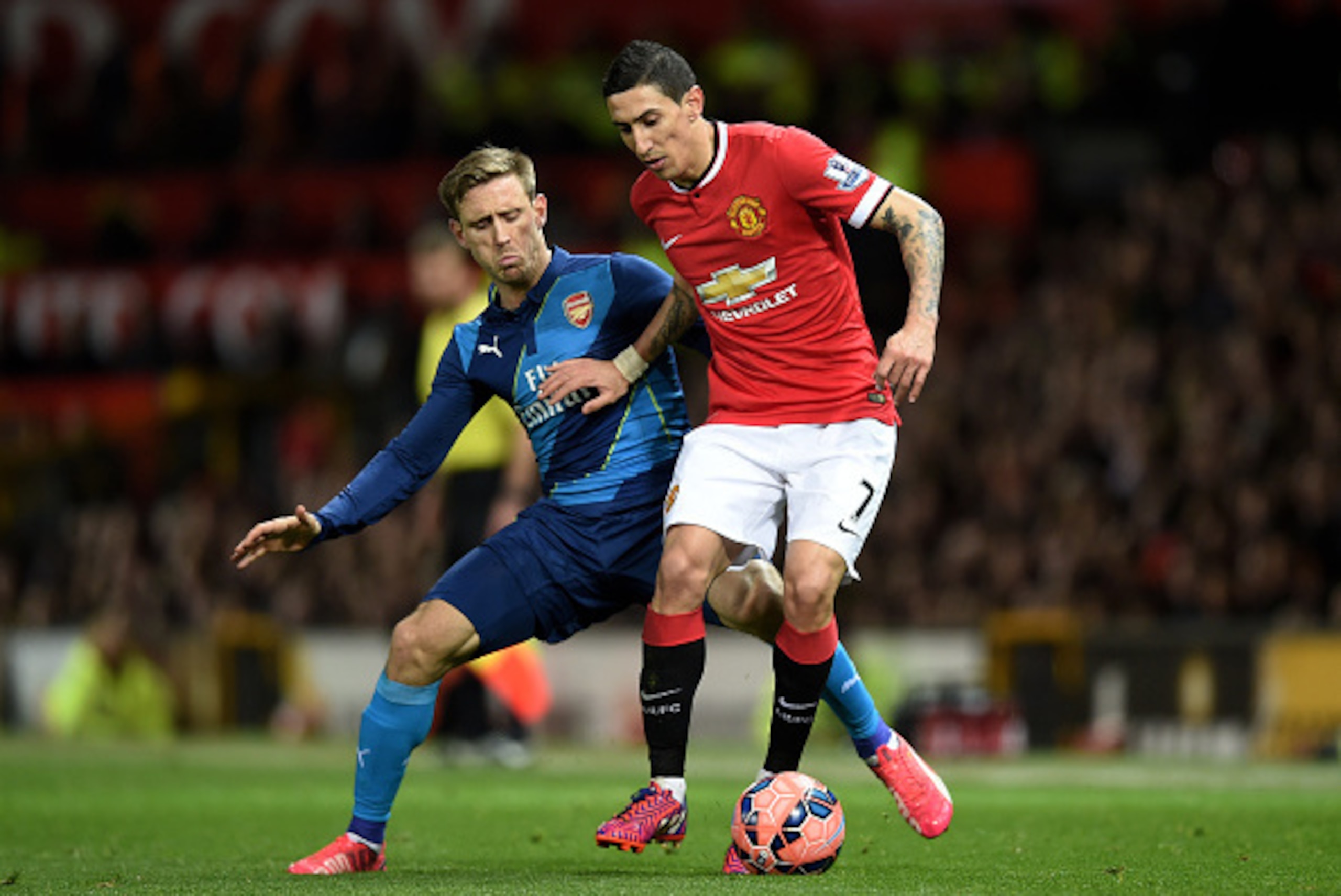 MANCHESTER, ENGLAND - MARCH 09:  Angel di Maria of Manchester United is challenged by Nacho Monreal of Arsenal during the FA Cup Quarter Final match between Manchester United and Arsenal at Old Trafford on March 9, 2015 in Manchester, England.  (Photo by 