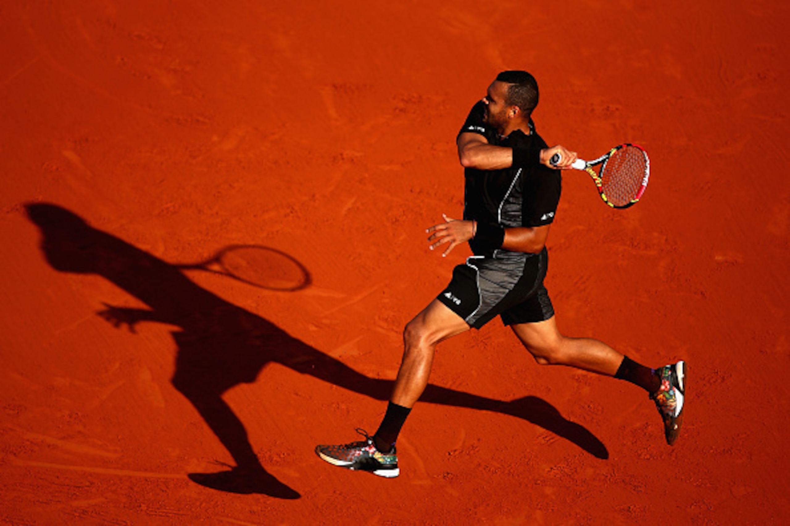 PARIS, FRANCE - JUNE 02:  Jo-Wilfried Tsonga of France returns a shot during his Men's quarter final match against Kei Nishikori of Japan on day of the 2015 French Open at Roland Garros on June 2, 2015 in Paris, France.  (Photo by Clive Brunskill/Getty Im