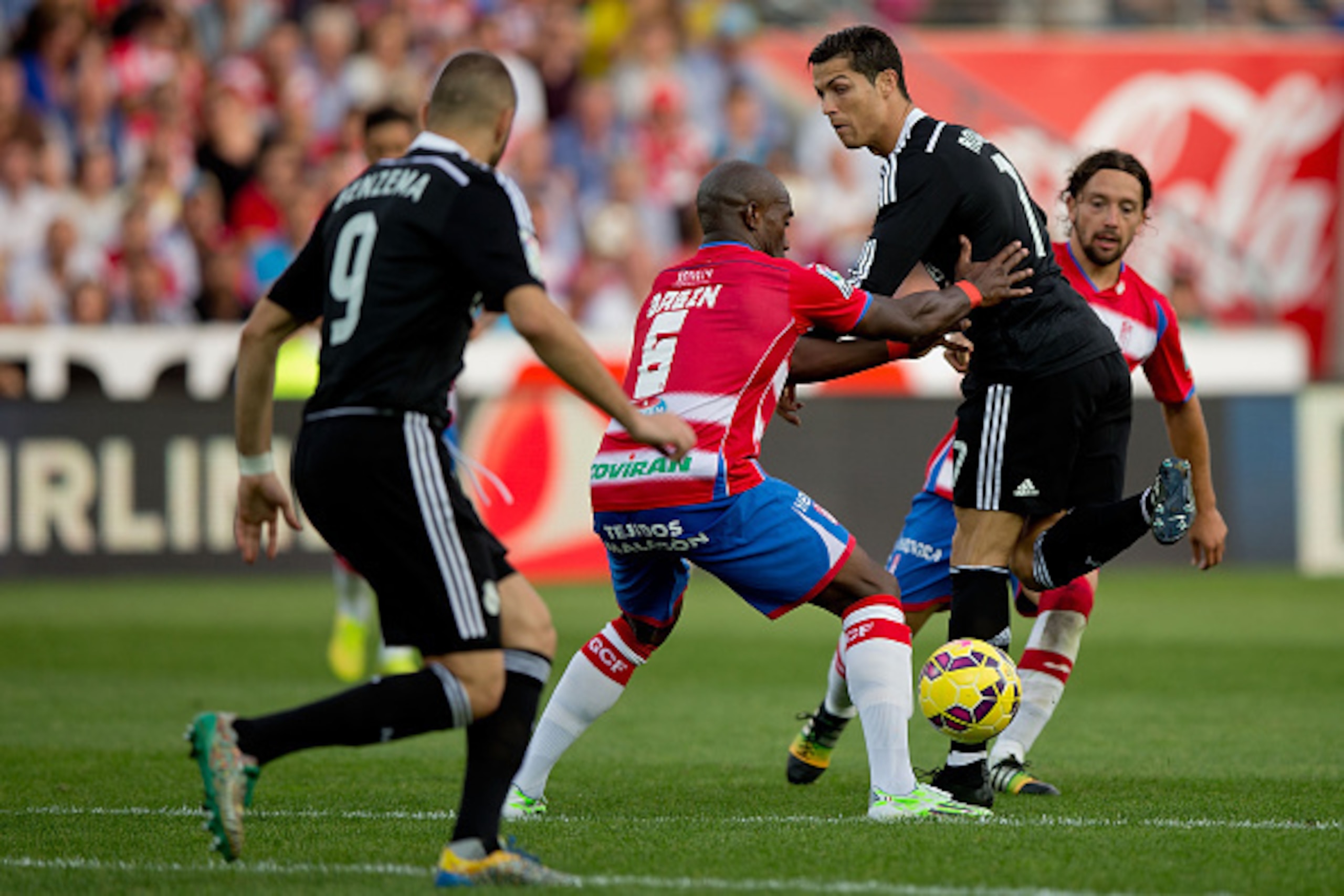 GRANADA, SPAIN - NOVEMBER 01: Cristiano Ronaldo (R) of Real Madrid CF heels the ball to his teammate Karim Benzema (L) prior to their third goal during the La Liga match between Granada CF and Real Madrid CF at Nuevo Estadio de Los Carmenes on November 1, GRANADA, SPAIN - NOVEMBER 01: Cristiano Ronaldo (R) of Real Madrid CF heels the ball to his teammate Karim Benzema (L) prior to their third goal during the La Liga match between Granada CF and Real Madrid CF at Nuevo Estadio de Los Carmenes on November 1,