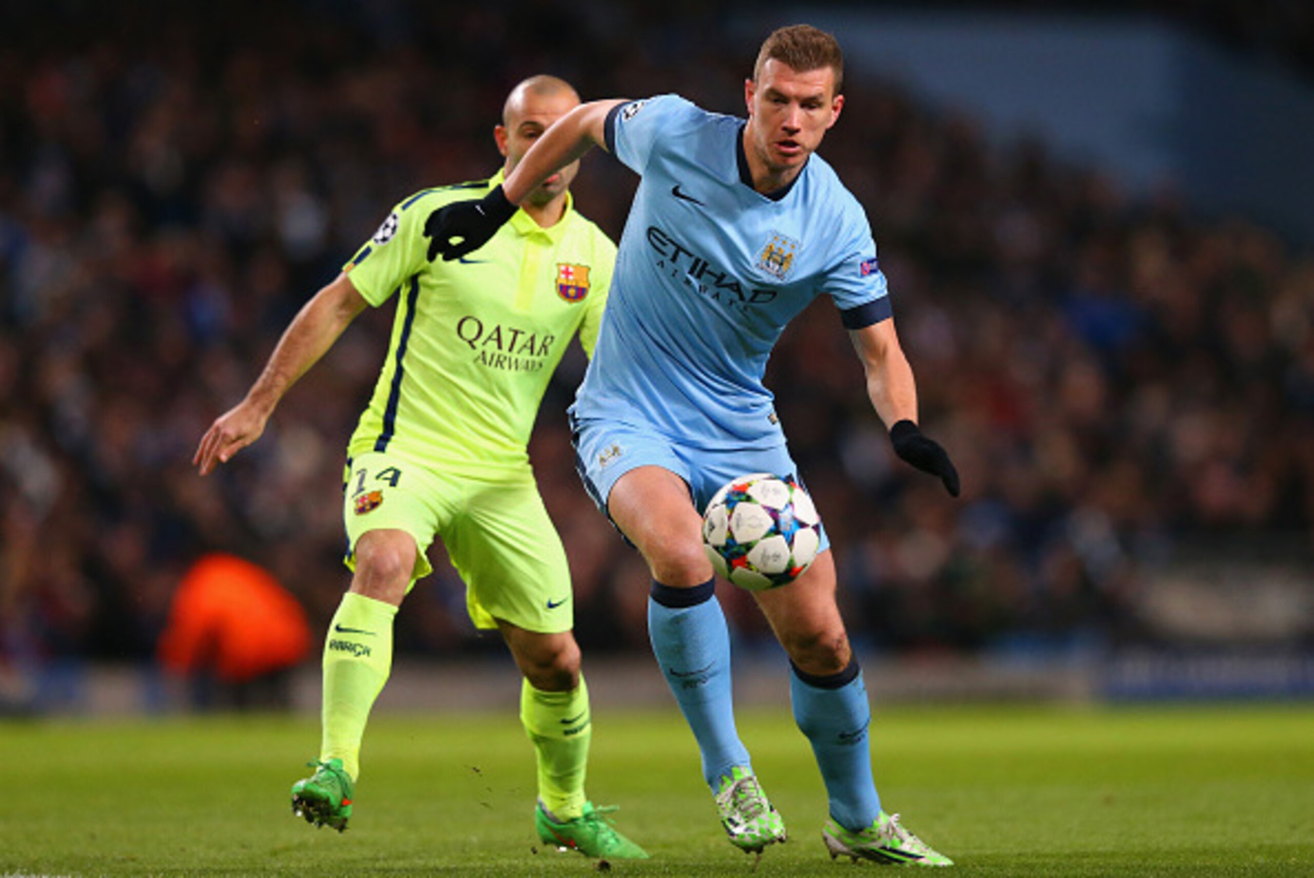 MANCHESTER, ENGLAND - FEBRUARY 24:  Javier Mascherano of Barcelona marshalls Edin Dzeko of Manchester City during the UEFA Champions League Round of 16 match between Manchester City and Barcelona at Etihad Stadium on February 24, 2015 in Manchester, Unite