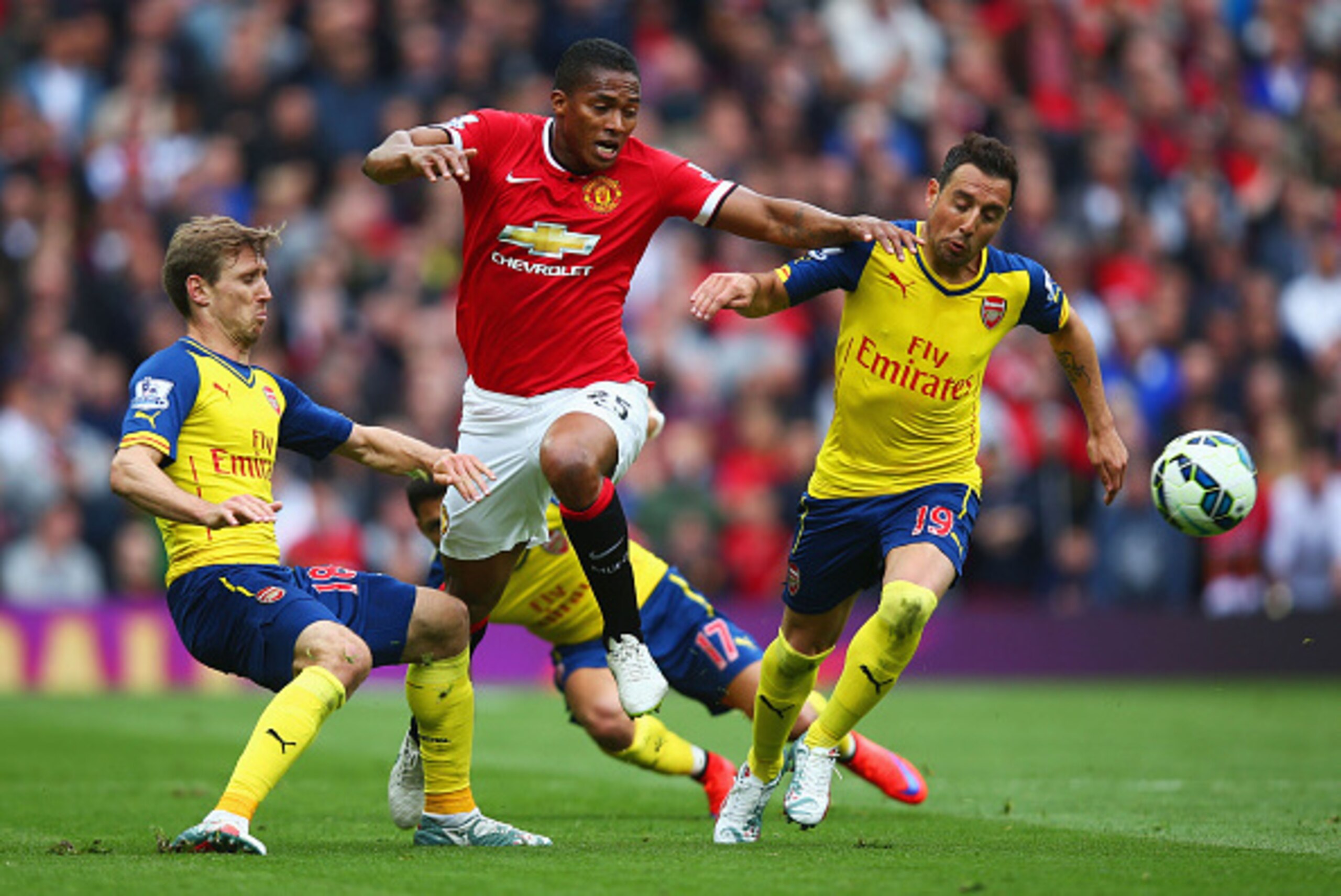 MANCHESTER, ENGLAND - MAY 17:  Luis Antonio Valencia of Manchester United takes on Nacho Monreal, Alexis Sanchez and Santi Cazorla of Arsenal during the Barclays Premier League match between Manchester United and Arsenal at Old Trafford on May 17, 2015 in