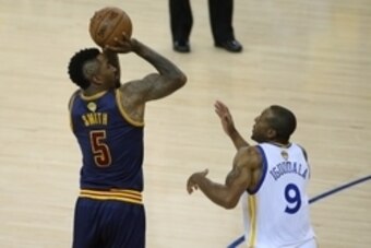 June 4, 2015; Oakland, CA, USA; Cleveland Cavaliers guard J.R. Smith (5) shoots against Golden State Warriors guard Andre Iguodala (9) during the second half in game one of the NBA Finals. at Oracle Arena. Mandatory Credit: Kelley L Cox-USA TODAY Sports