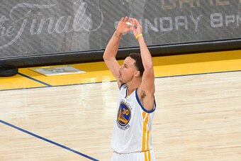 OAKLAND,CA - JUNE 4:  Stephen Curry #30 of the Golden State Warriors gets the crowd pumped up in overtime against the Cleveland Cavaliers at the Oracle Arena During Game one of the 2015 NBA Finals on June 4, 2015 in Oakland, California NOTE TO USER: User