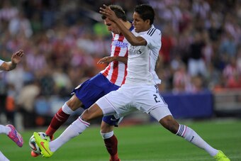 MADRID, SPAIN - AUGUST 22:  Mario Mandzukic of Club Atletico de Madrid beats Raphael Varane of Real Madrid to score his team's opening goal during the Supercopa, second leg match between Club Atletico de Madrid and Real Madrid at Vicente Caldron stadium o