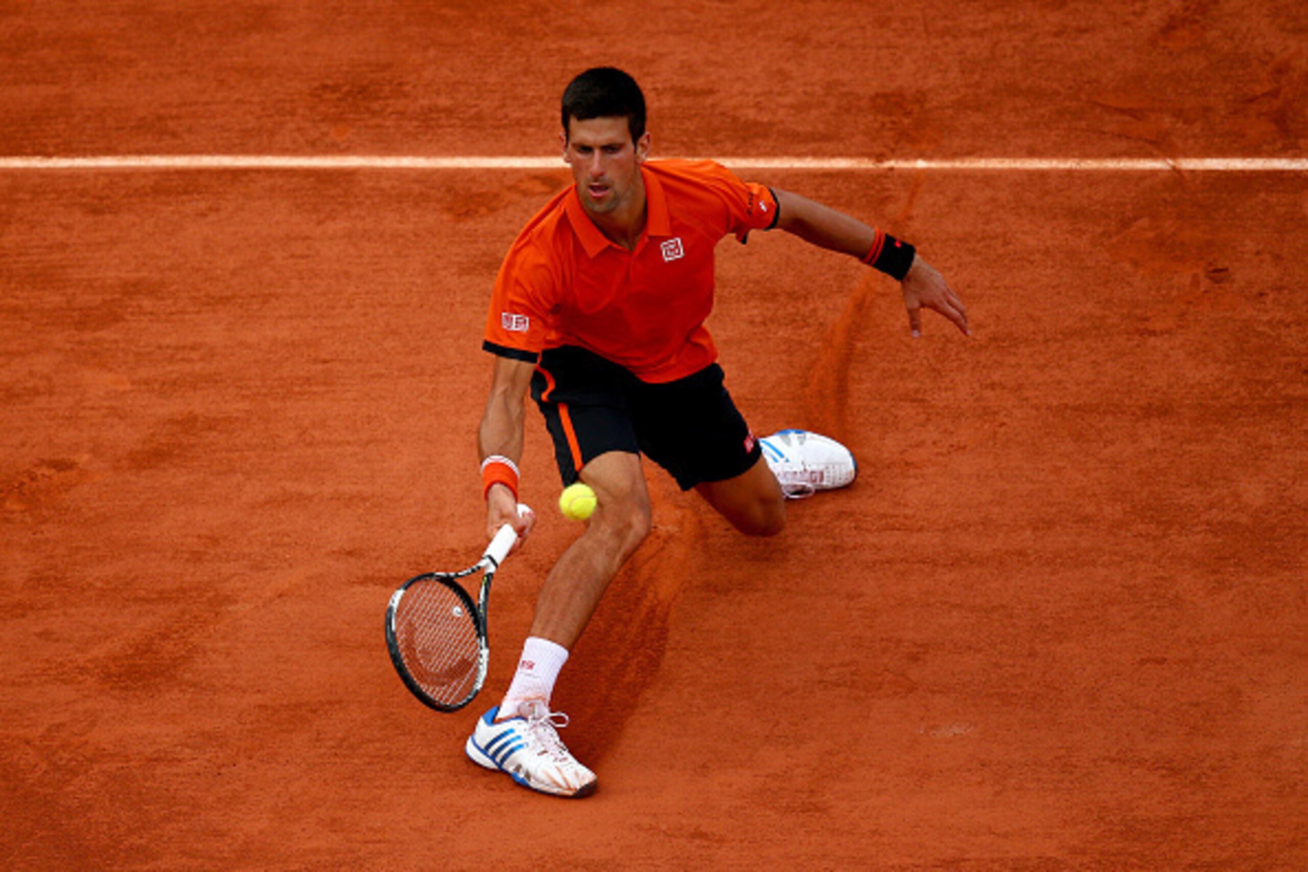 PARIS, FRANCE - JUNE 05:  Novak Djokovic of Serbia returns a shot in his Men's Semi Final match against Andy Murray of Great Britain on day thirteen of the 2015 French Open at Roland Garros on June 5, 2015 in Paris, France.  (Photo by Dan Istitene/Getty I