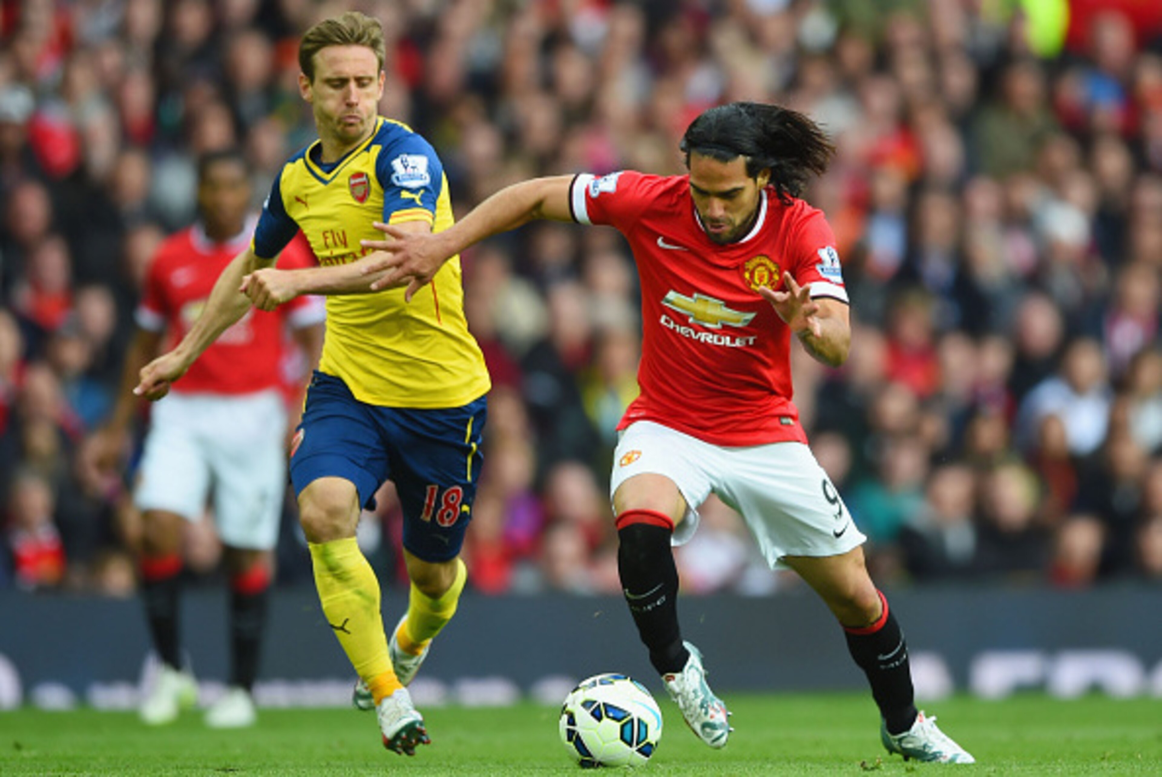 MANCHESTER, ENGLAND - MAY 17:  Radamel Falcao Garcia of Manchester United takes on Nacho Monreal of Arsenal during the Barclays Premier League match between Manchester United and Arsenal at Old Trafford on May 17, 2015 in Manchester, England.  (Photo by S