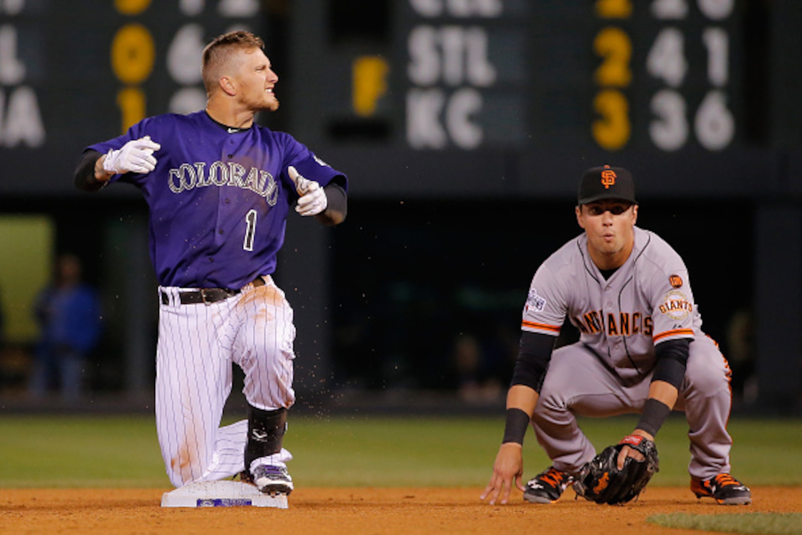 DENVER, CO - MAY 23:  Brandon Barnes #1 of the Colorado Rockies celebrates after sliding safely in to second with an RBI double against second baseman Joe Panik #12 of the San Francisco Giants to score Ben Paulsen #10 of the Colorado Rockies and tie the s