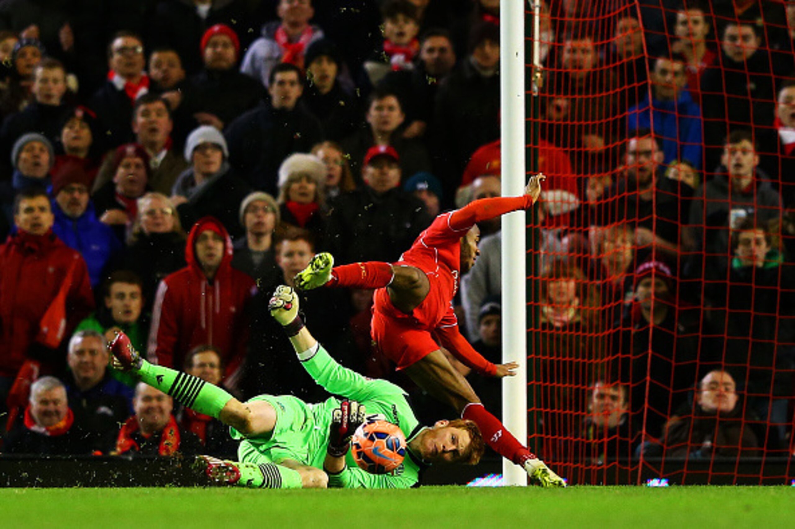 LIVERPOOL, ENGLAND - JANUARY 24:  Adam Bogdan of Bolton Wanderers collides with Raheem Sterling of Liverpool as he makes a block during the FA Cup Fourth Round match between Liverpool and Bolton Wanderers at Anfield on January 24, 2015 in Liverpool, Engla