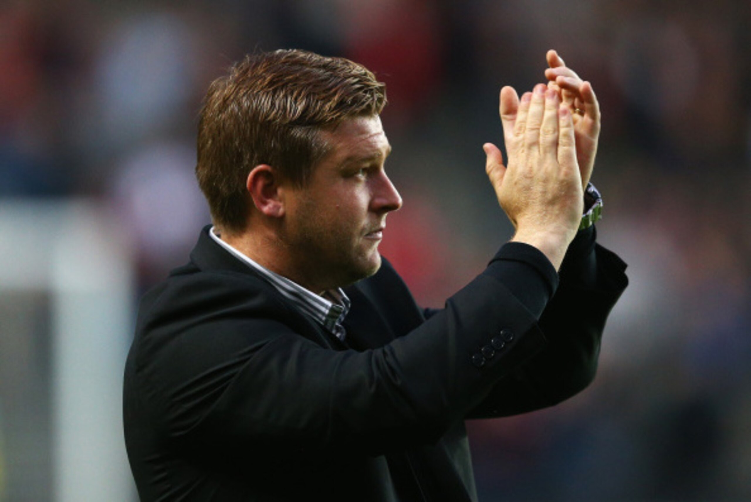 MILTON KEYNES, ENGLAND - AUGUST 26: Karl Robinson, manager of Milton Keynes Dons applauds the fans prior to the Capital One Cup Second Round match between MK Dons and Manchester United at Stadium mk on August 26, 2014 in Milton Keynes, England.  (Photo by