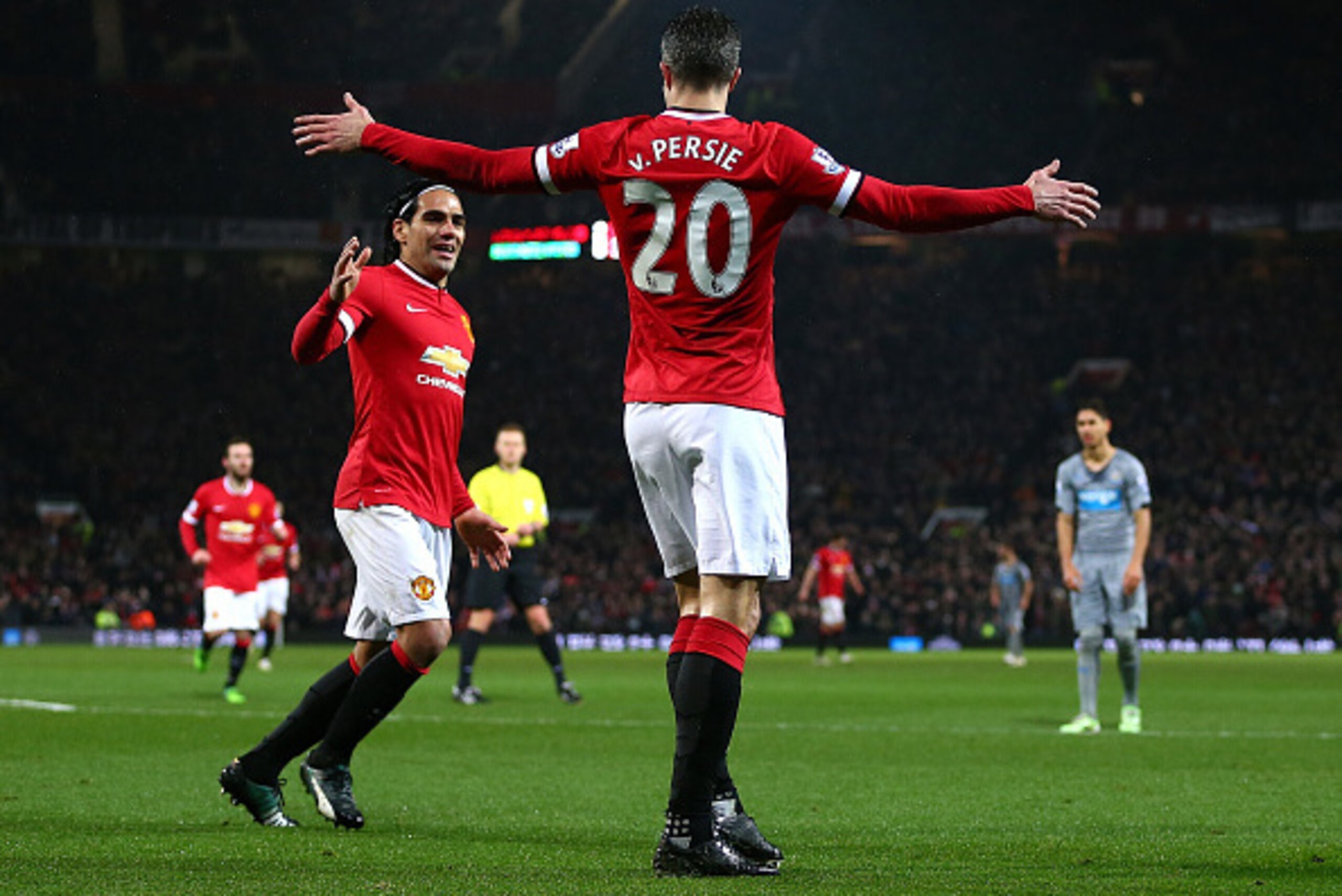 MANCHESTER, ENGLAND - DECEMBER 26:  Robin van Persie of Manchester United celebrates scoring the third goal with team-mate Radamel Falcao during the Barclays Premier League match between Manchester United and Newcastle United at Old Trafford on December 2
