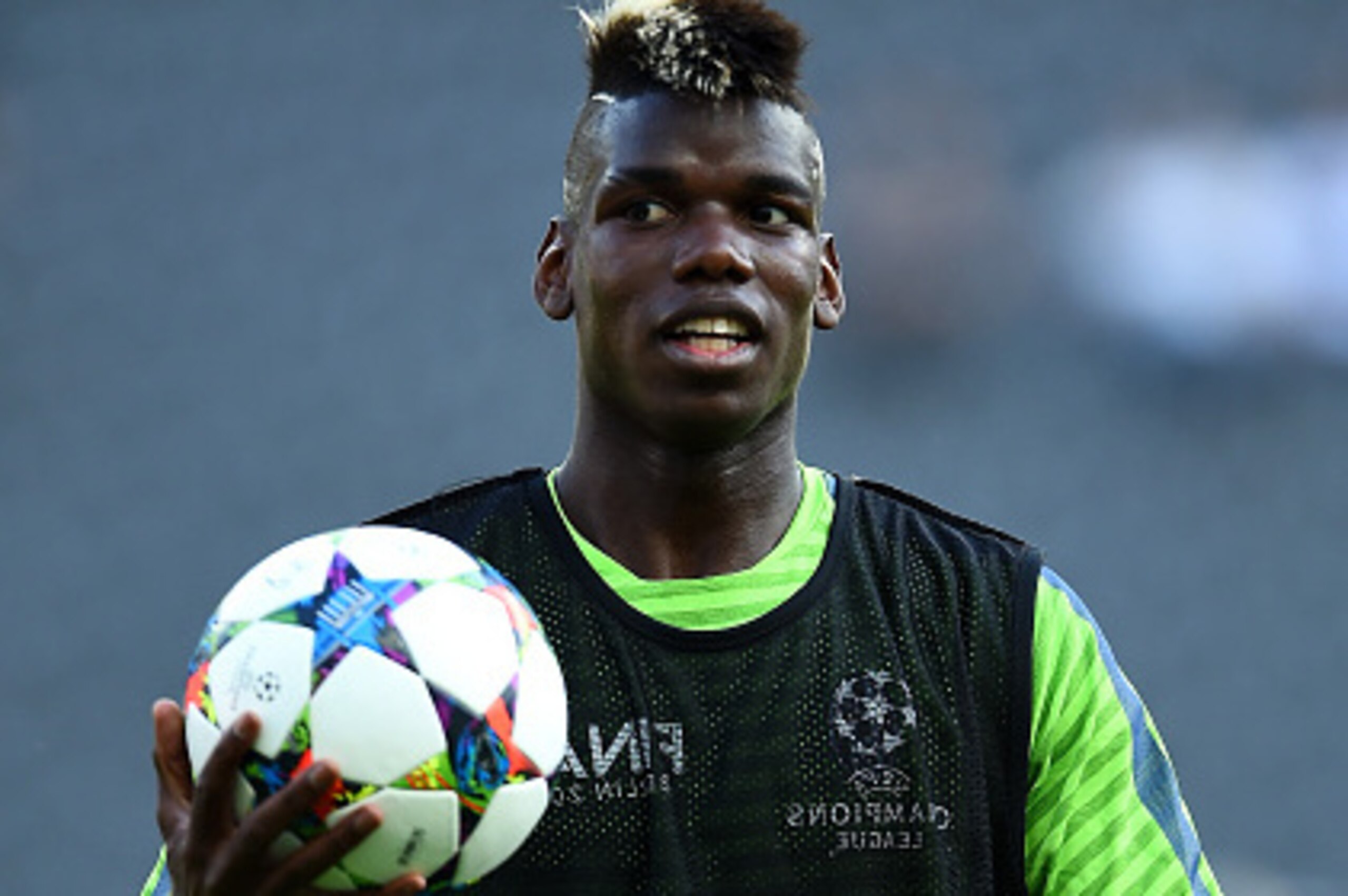 BERLIN, GERMANY - JUNE 05:  Paul Pogba of Juventus gathers the ball during a Juventus training session on the eve of the UEFA Champions League Final match against FC Barcelona at Olympiastadion on June 5, 2015 in Berlin, Germany.  (Photo by Laurence Griff