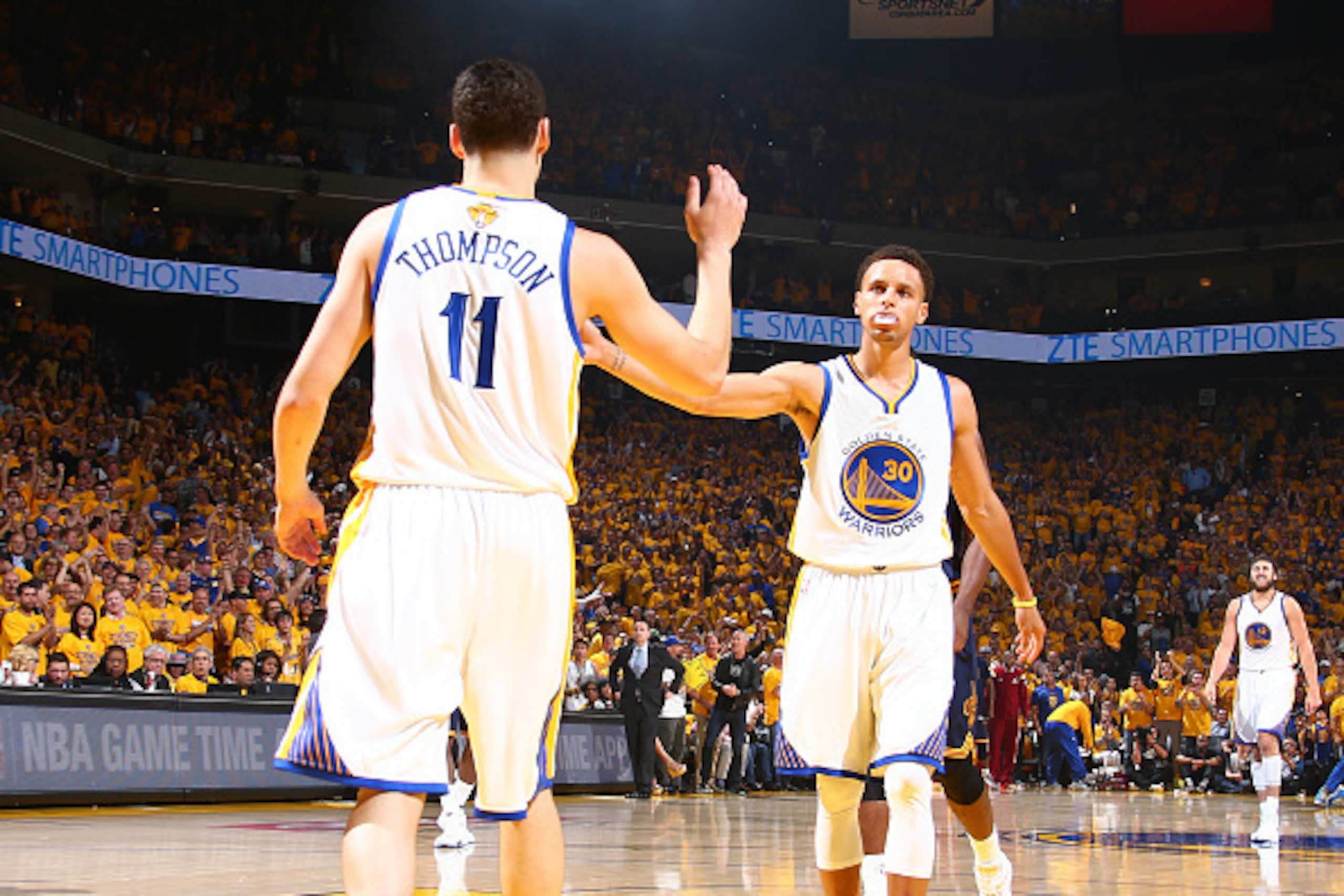 OAKLAND, CA - JUNE 4: Teammates Klay Thompson #11 of the Golden State Warriors and Stephen Curry #30 of the Golden State Warriors high-five during Game One of the 2015 NBA Finals on June 4, 2015 at Oracle Arena in Oakland, California. NOTE TO USER: User e
