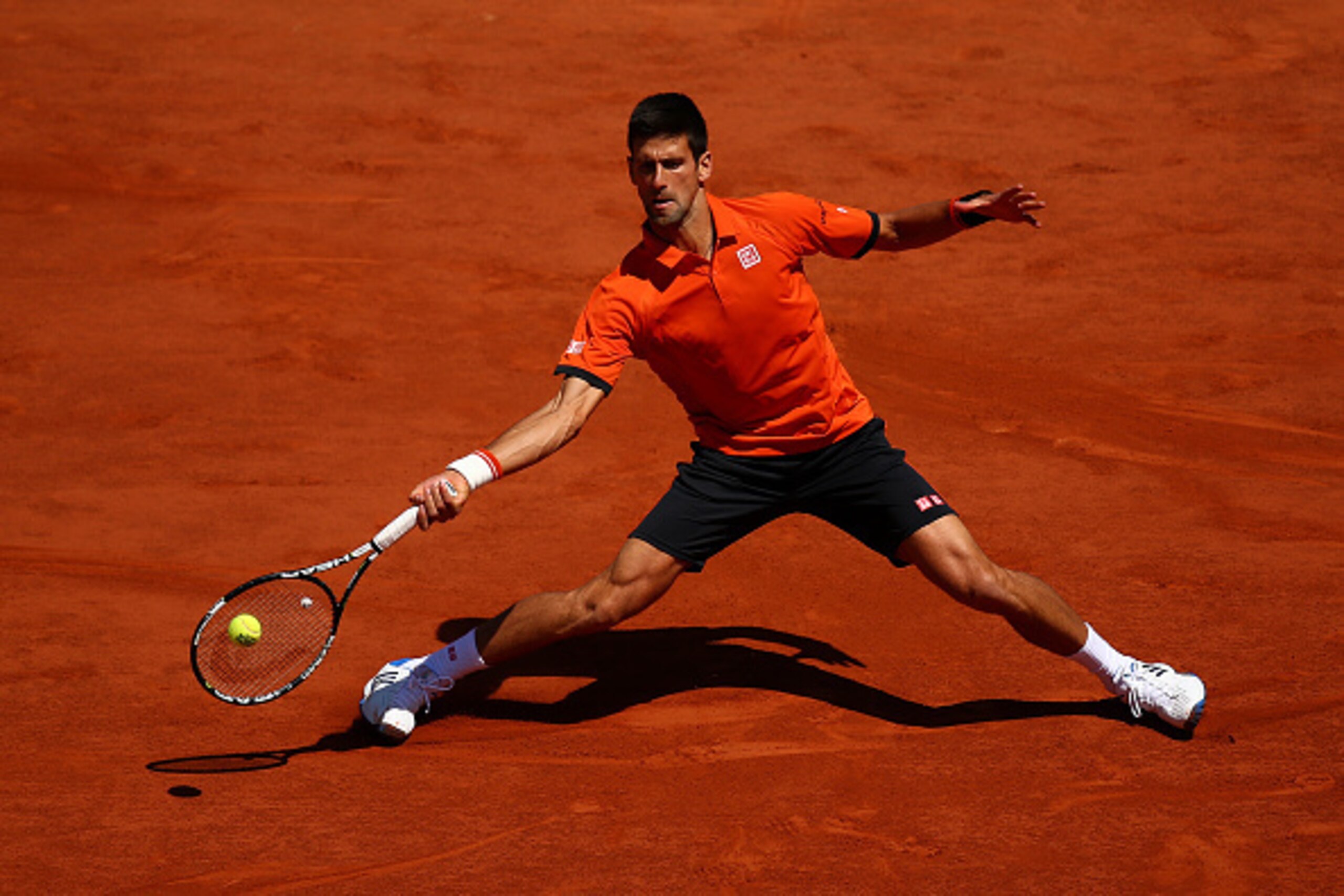 PARIS, FRANCE - JUNE 06:  Novak Djokovic of Serbia returns a shot in his Men's Semi Final match against Andy Murray of Great Britain on day fourteen of the 2015 French Open at Roland Garros on June 6, 2015 in Paris, France.  (Photo by Dan Istitene/Getty I