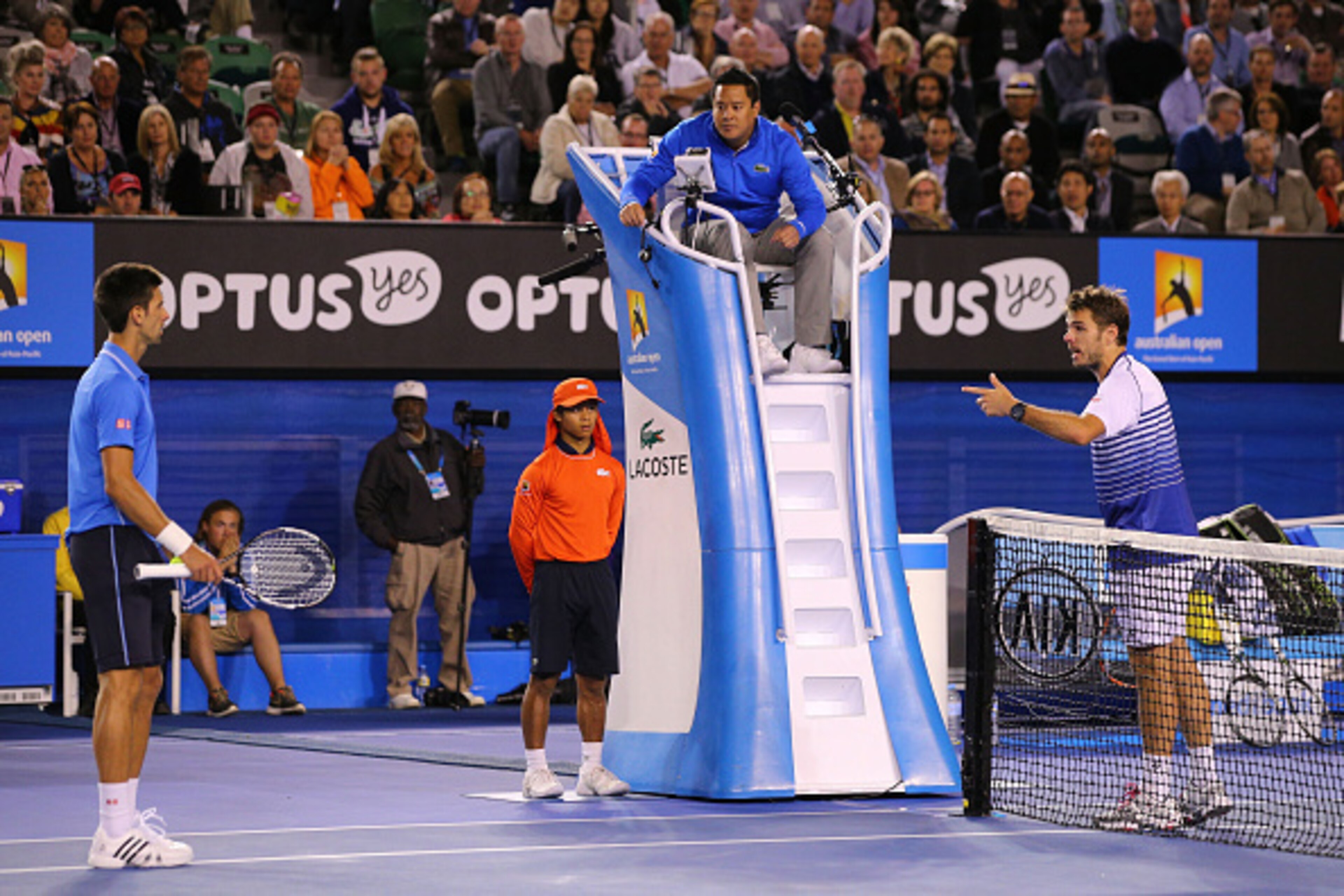 MELBOURNE, AUSTRALIA - JANUARY 30:  Novak Djokovic of Serbia speaks to Stanislas Wawrinka of Switzerland in their semifinal match during day 12 of the 2015 Australian Open at Melbourne Park on January 30, 2015 in Melbourne, Australia.  (Photo by Michael D