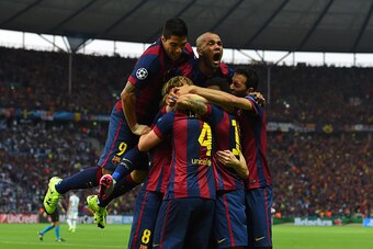 BERLIN, GERMANY - JUNE 06:  Luis Suarez and Daniel Alves of Barcelona celebrate with team mates after the goal scored by Ivan Rakitic during the UEFA Champions League Final between Juventus and FC Barcelona at Olympiastadion on June 6, 2015 in Berlin, Ger