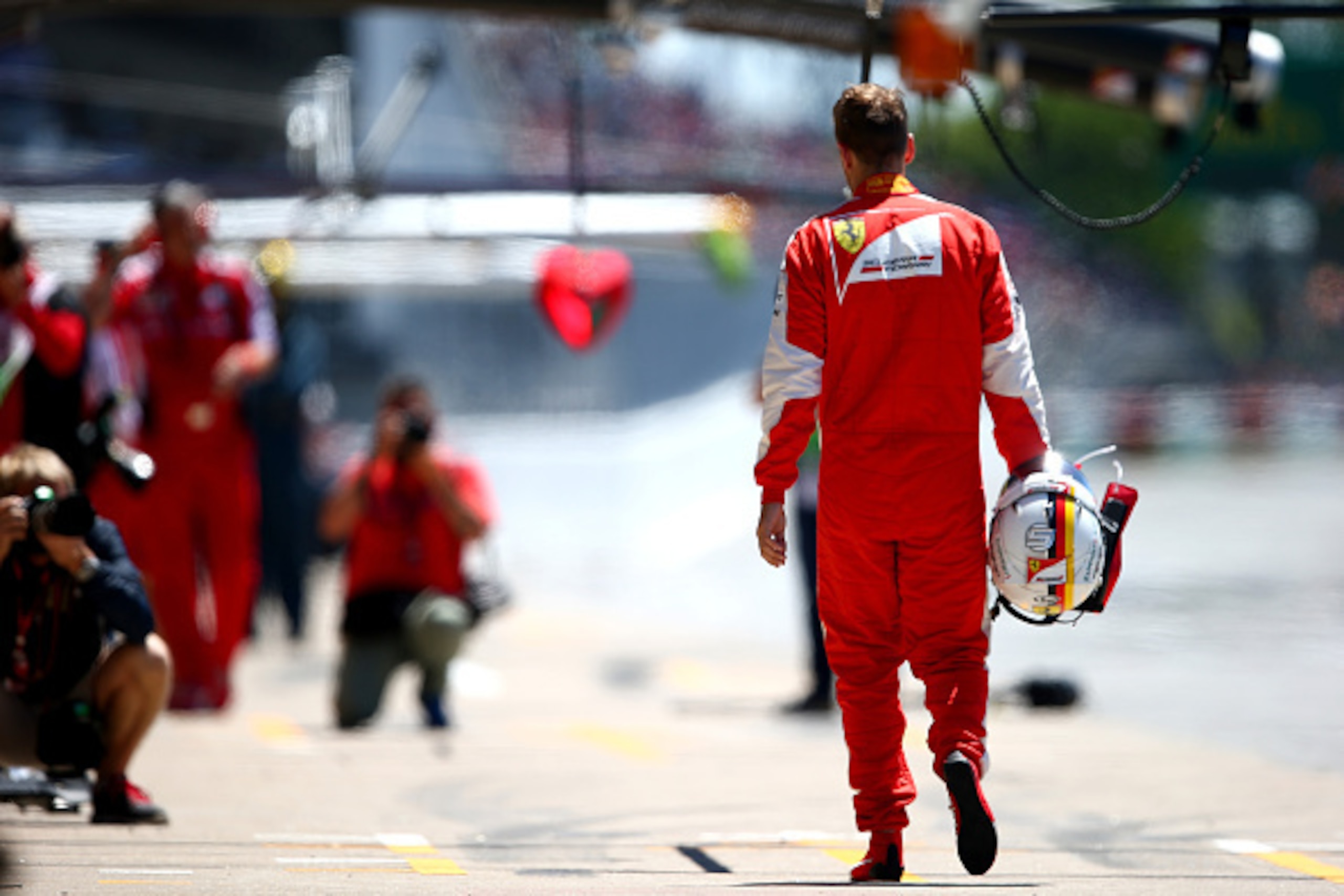 MONTREAL, QC - JUNE 06:  A dejected Sebastian Vettel of Germany and Ferrari walks back to the pits during qualifying for the Canadian Formula One Grand Prix at Circuit Gilles Villeneuve on June 6, 2015 in Montreal, Canada.  (Photo by Mark Thompson/Getty I