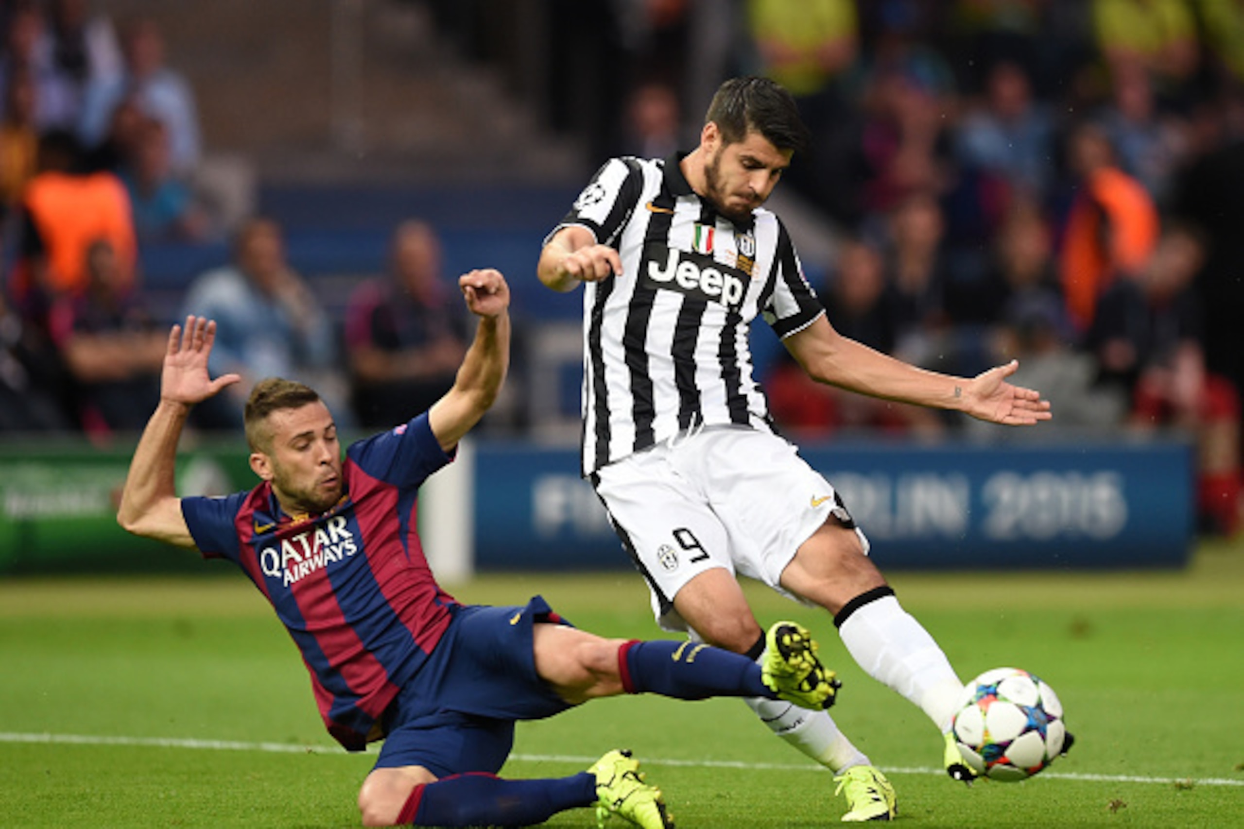 BERLIN, GERMANY - JUNE 06: Alvaro Morata of Juventus is challenged by Jordi Alba of Barcelona during the UEFA Champions League Final between Juventus and FC Barcelona at Olympiastadion on June 6, 2015 in Berlin, Germany.  (Photo by Matthias Hangst/Getty I