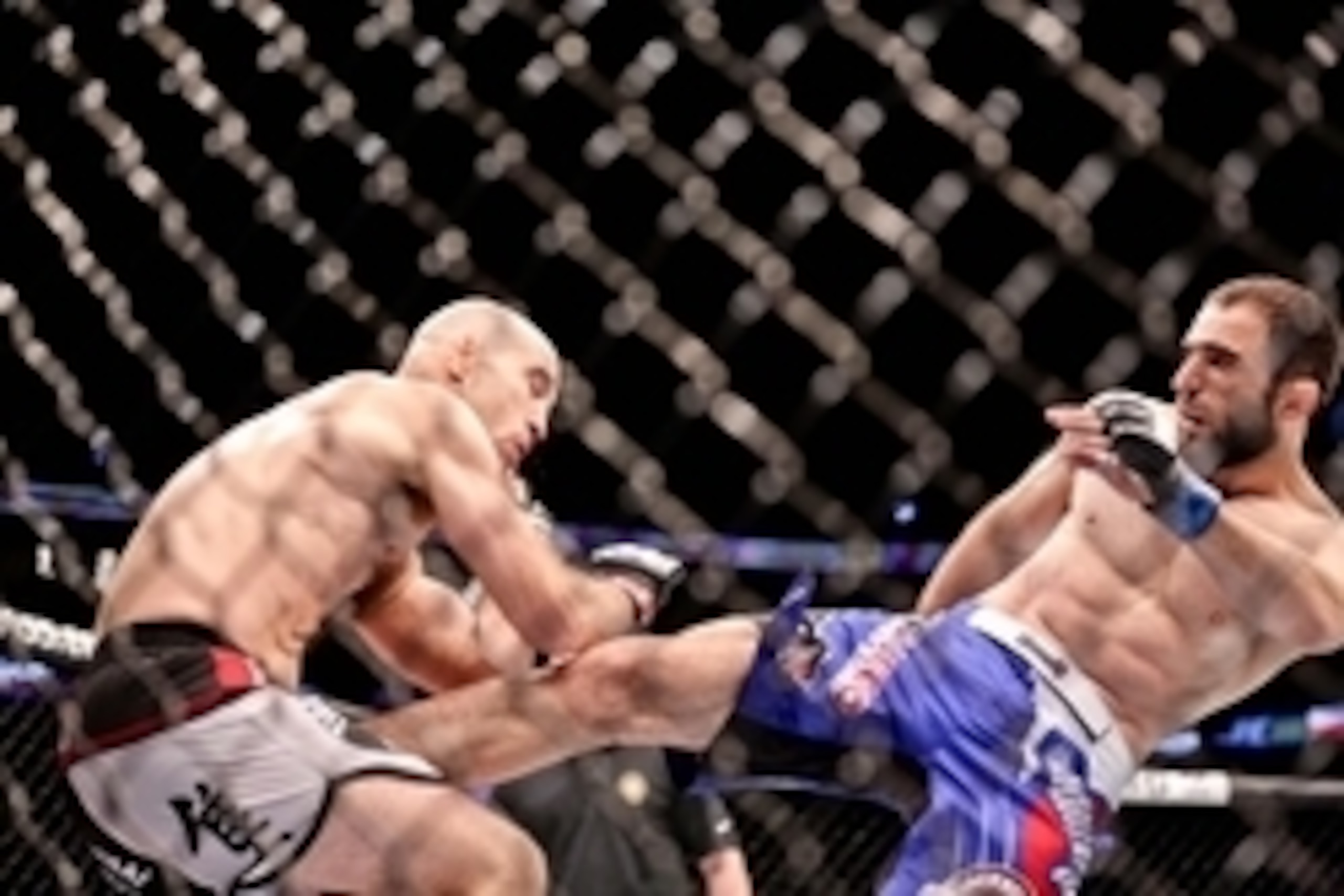 Jun 6, 2015; New Orleans, LA, USA; Omari Akhmedov (blue gloves) kicks Brian Ebersole (red gloves) during UFC Fight Night at the Smoothie King Center. Mandatory Credit: Derick E. Hingle-USA TODAY Sports