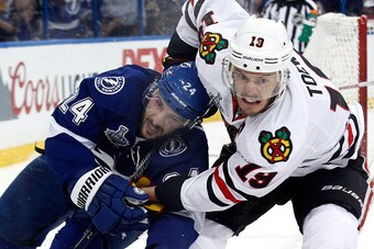 TAMPA, FL - JUNE 03: Jonathan Toews #19 of the Chicago Blackhawks and Ryan Callahan #24 of the Tampa Bay Lightning battle for the puck during Game One of the 2015 NHL Stanley Cup Final at Amalie Arena on June 3, 2015 in Tampa, Florida.  (Photo by Scott Is
