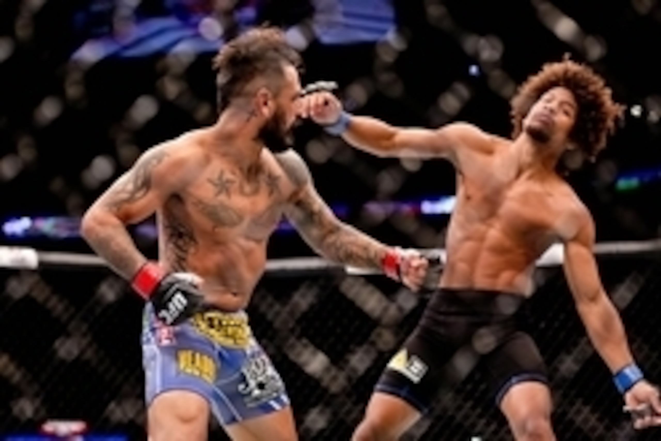 Jun 6, 2015; New Orleans, LA, USA; Francisco Rivera (red gloves) knocks out Alex Caceres (blue gloves) during UFC Fight Night at the Smoothie King Center. Mandatory Credit: Derick E. Hingle-USA TODAY Sports