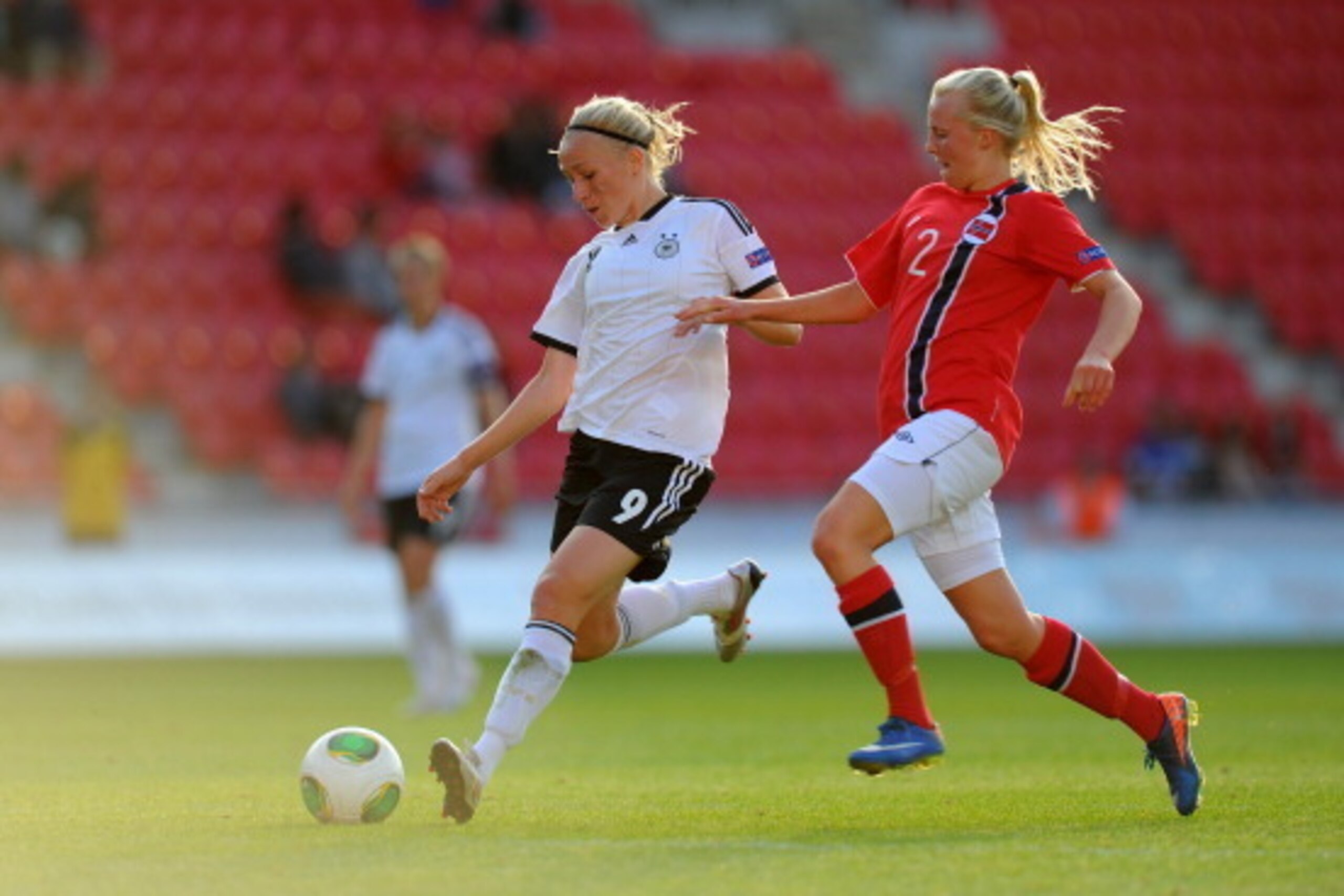 LLANELLI, WALES - AUGUST 19:  Germany forward Pauline Bremer (l) shoots to score the third goal watched by Norway defender Mali Lilleas Naess during the UEFA Women's U19 Tournament Group B match between Germany U19 Women v Norway U19 Women at Parc y Scarl