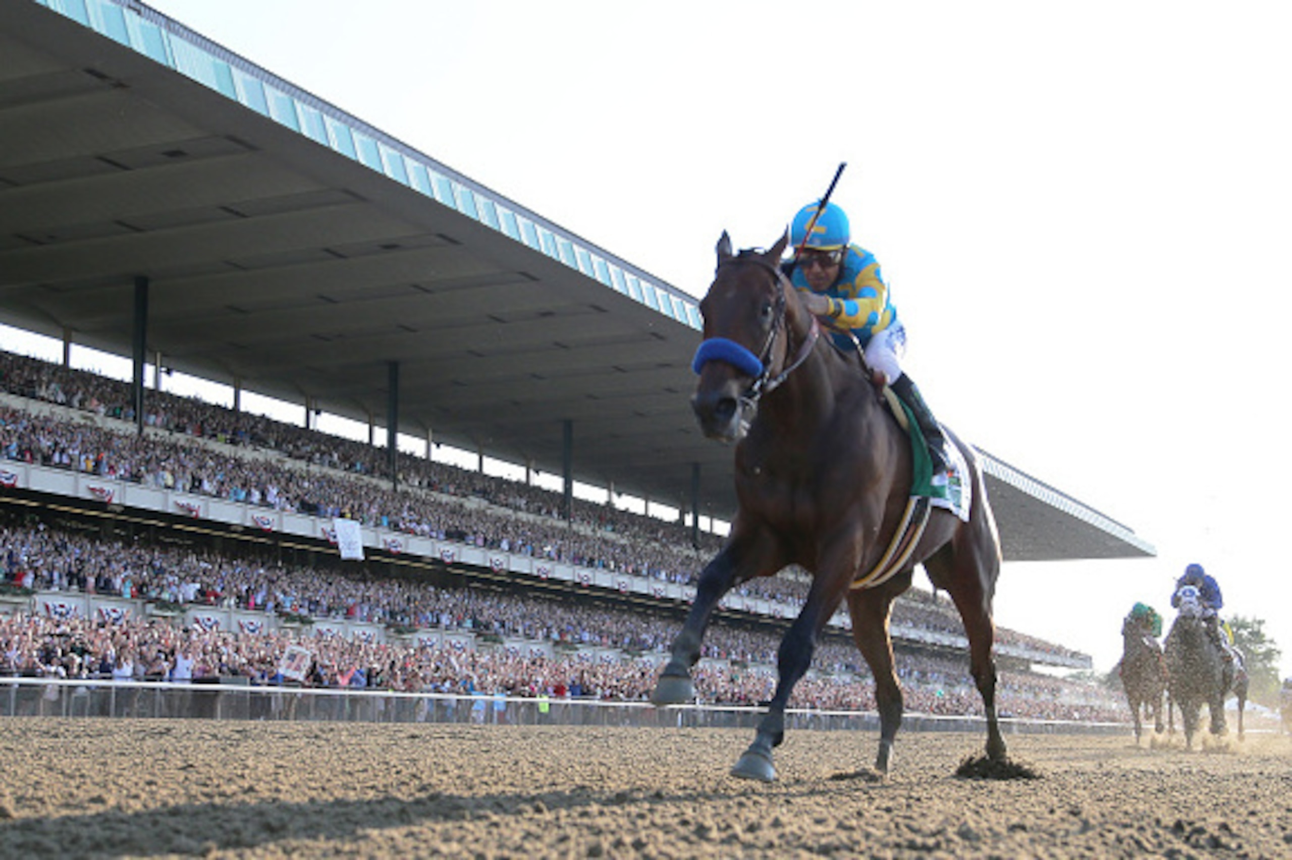 ELMONT, NY - JUNE 06:  American Pharoah #5, ridden by Victor Espinoza, crosses the finish line ahead of Frosted #6, ridden by Joel Rosario, and Keen Ice #7, ridden by Kent Desormeaux, to win the 147th running of the Belmont Stakes at Belmont Park on June 