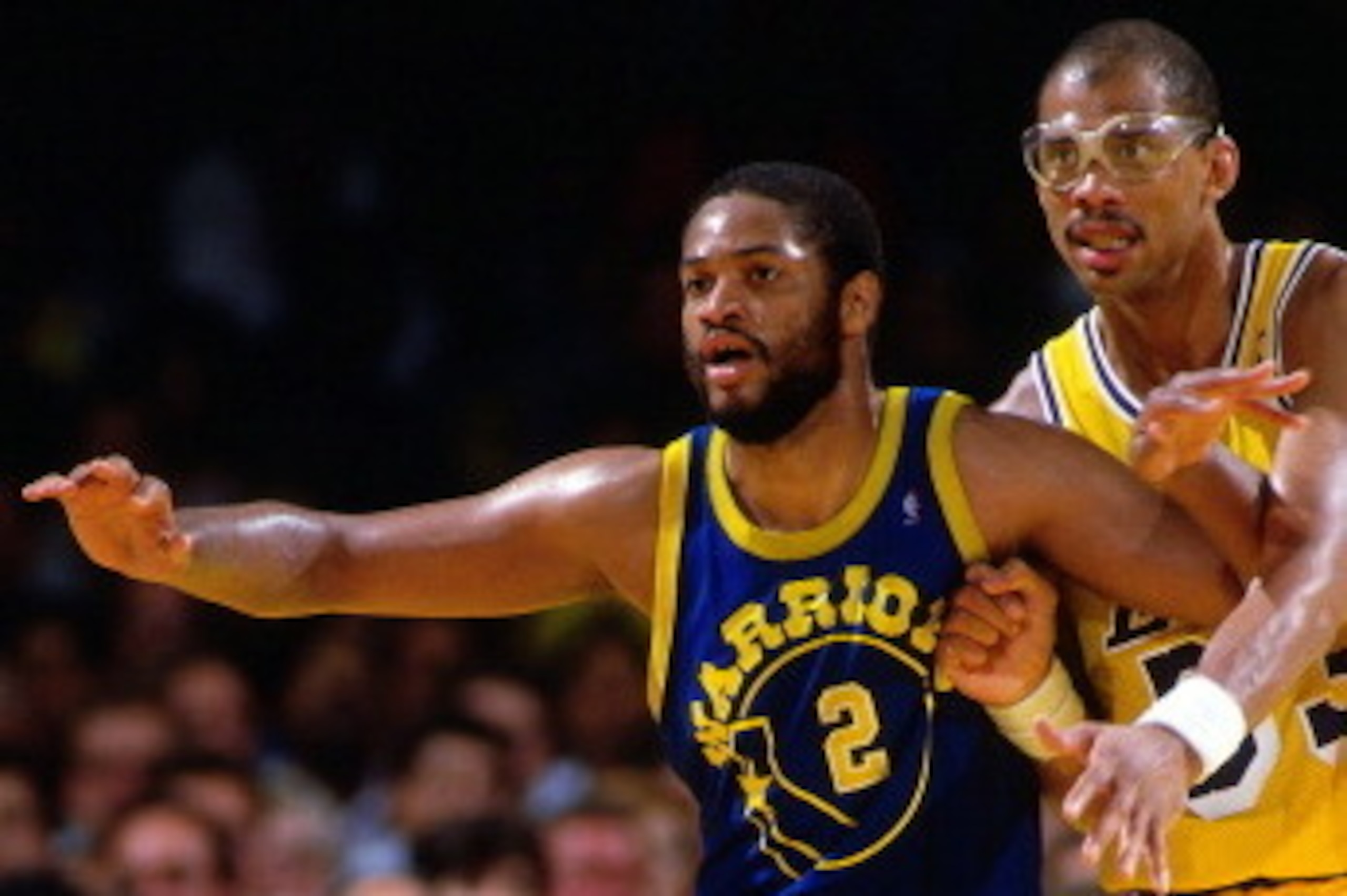 INGLEWOOD, CA - CIRCA 1987: Joe Barry Carroll #2 of the Golden State Warriors posts up against Kareem Abdul Jabbar #33 of the Los Angeles Lakers circa 1987 at the Great Western Forum in Inglewood, California. NOTE TO USER: User expressly acknowledges and 