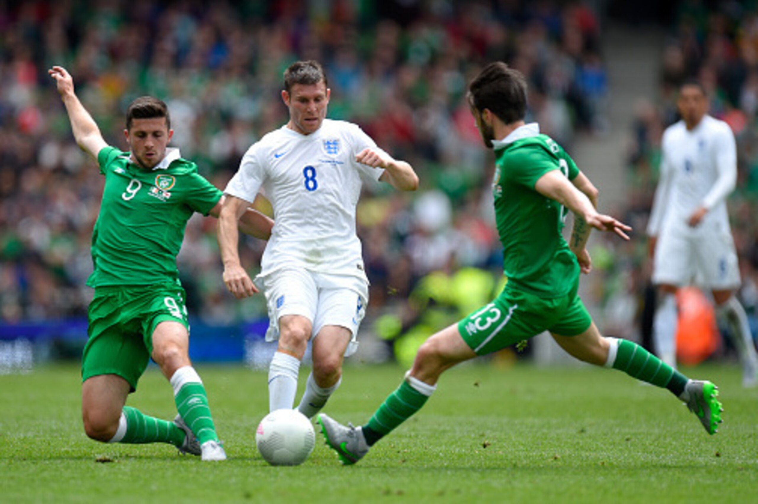 DUBLIN, IRELAND - JUNE 07:  England player James Milner (c) is challenged by Shane Long (l) and Harry Arter during the International friendly match between Ireland and England at Aviva Stadium on June 7, 2015 in Dublin, Ireland.  (Photo by Stu Forster/Get