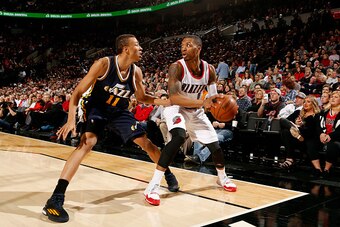 PORTLAND, OR - FEBRUARY 3:  Damian Lillard #0 of the Portland Trail Blazers handles the ball against Dante Exum #11 of the Utah Jazz on February 3, 2015 at the Moda Center Arena in Portland, Oregon. NOTE TO USER: User expressly acknowledges and agrees tha
