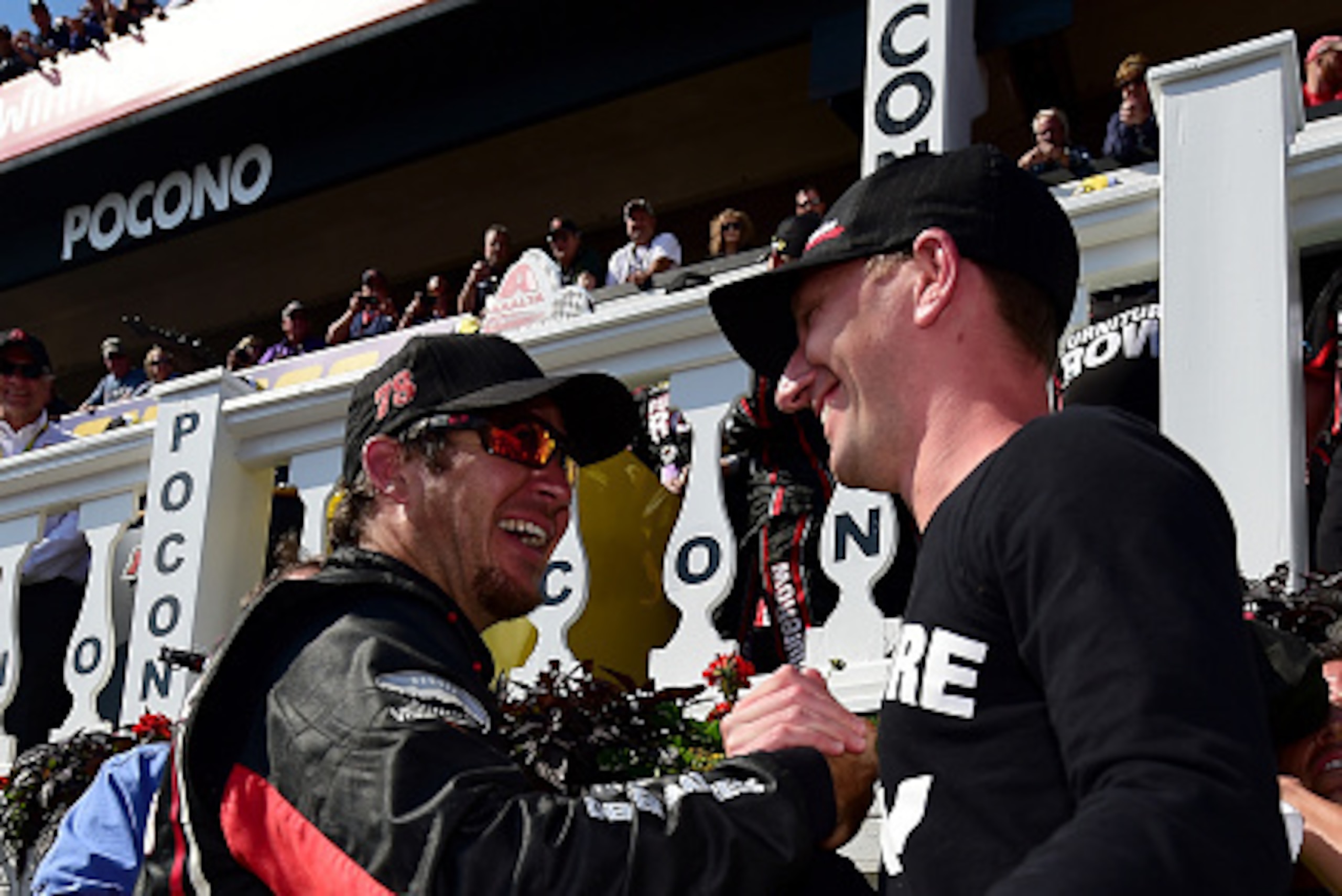 LONG POND, PA - JUNE 07:  Martin Truex Jr., driver of the #78 Furniture Row/Visser Precision Chevrolet, celebrates in Victory Lane with crew chief Cole Pearn after winning the NASCAR Sprint Cup Series Axalta 'We Paint Winners' 400 at Pocono Raceway on Jun
