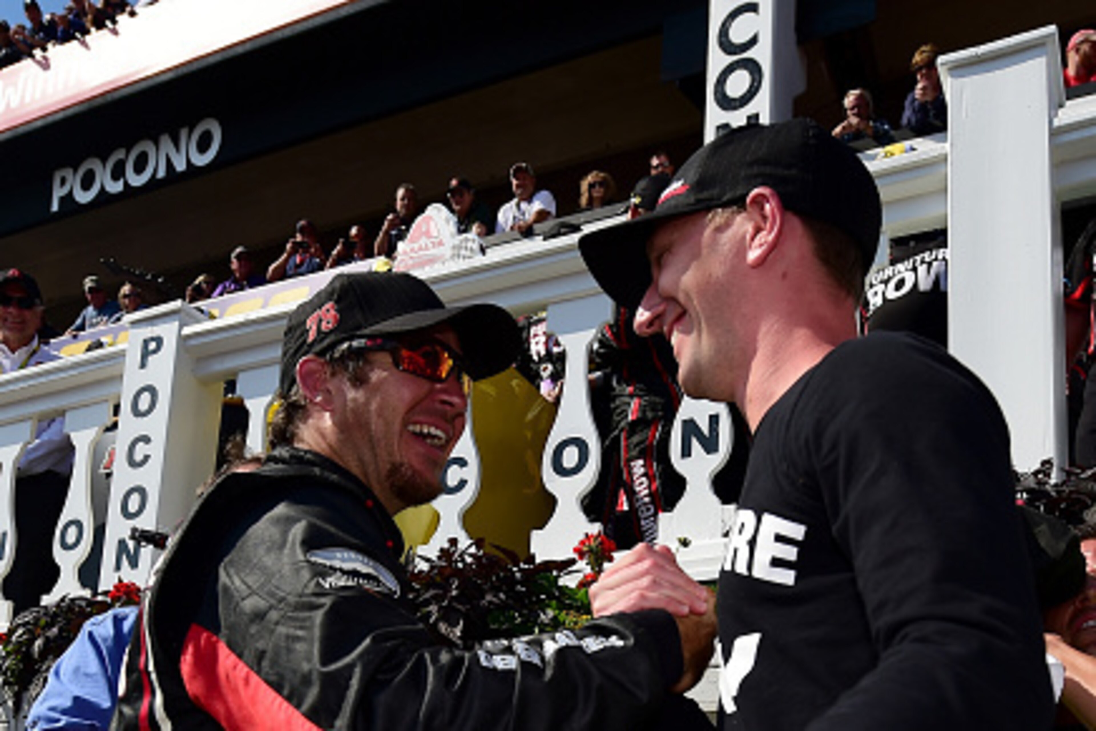 LONG POND, PA - JUNE 07:  Martin Truex Jr., driver of the #78 Furniture Row/Visser Precision Chevrolet, celebrates in Victory Lane with crew chief Cole Pearn after winning the NASCAR Sprint Cup Series Axalta 'We Paint Winners' 400 at Pocono Raceway on Jun