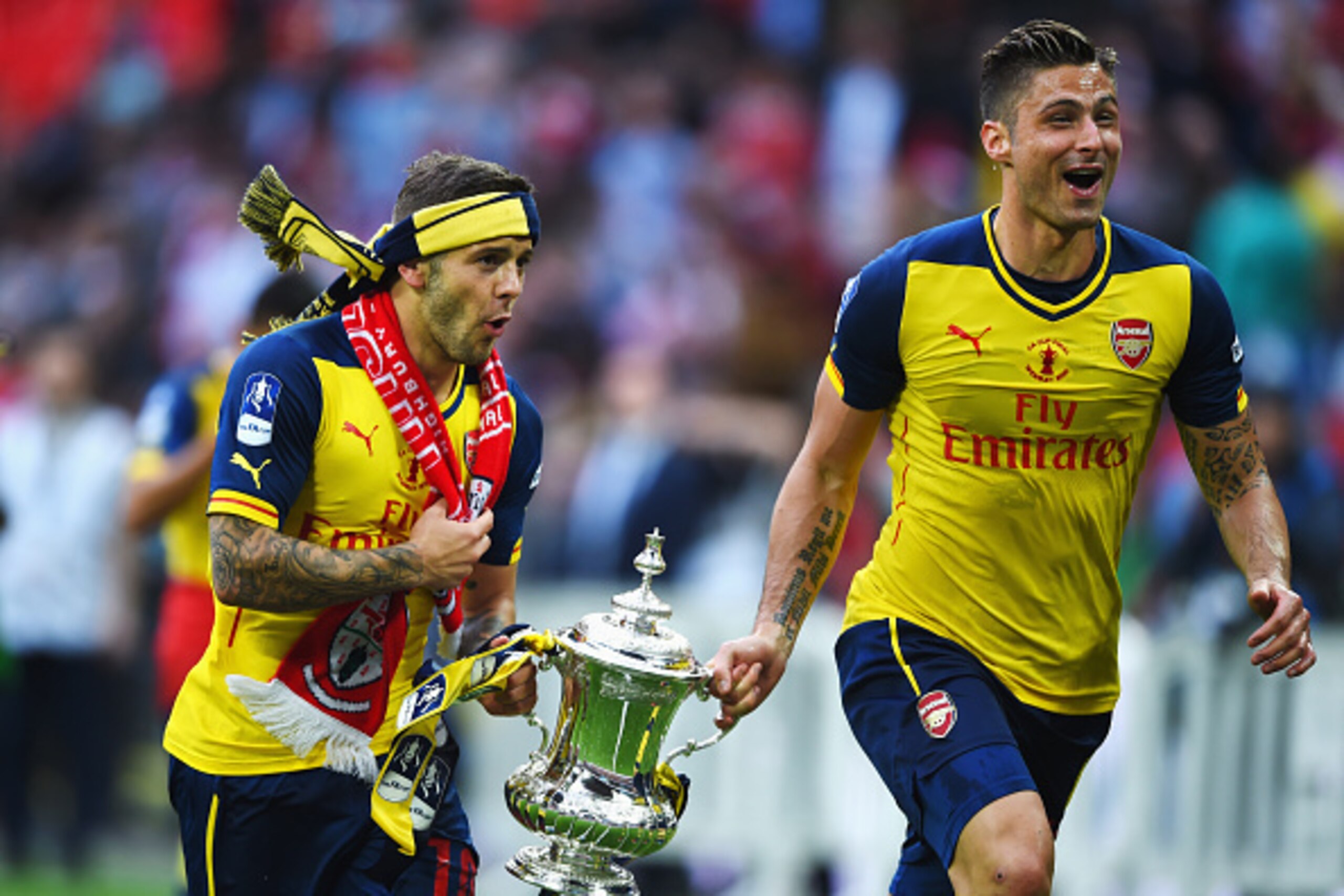 LONDON, ENGLAND - MAY 30: Jack Wilshere and Olivier Giroud of Arsenal celebrate victory with the trophy after the FA Cup Final between Aston Villa and Arsenal at Wembley Stadium on May 30, 2015 in London, England. Arsenal beat Aston Villa 4-0. (Photo by LONDON, ENGLAND - MAY 30: Jack Wilshere and Olivier Giroud of Arsenal celebrate victory with the trophy after the FA Cup Final between Aston Villa and Arsenal at Wembley Stadium on May 30, 2015 in London, England. Arsenal beat Aston Villa 4-0. (Photo by
